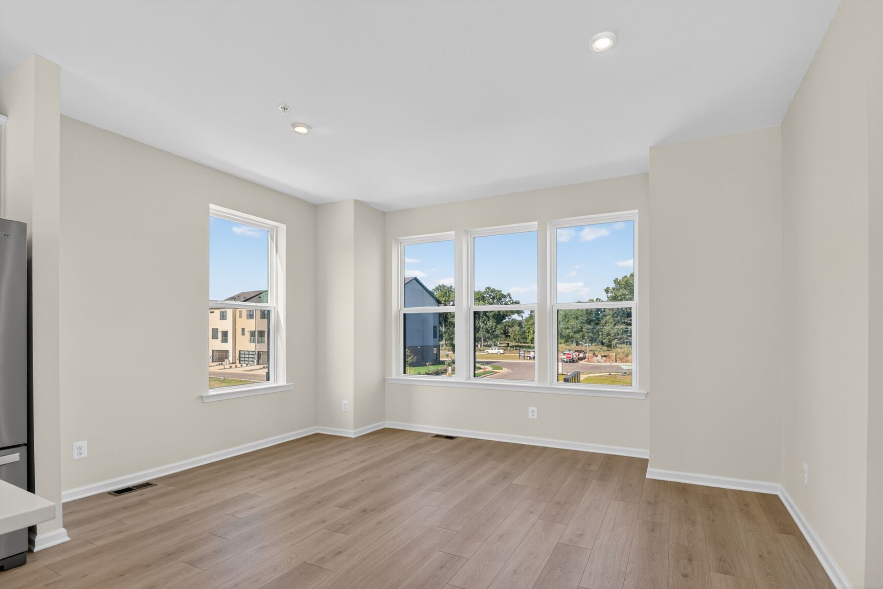 dining room off the kitchen with designer flooring and bright light from windows