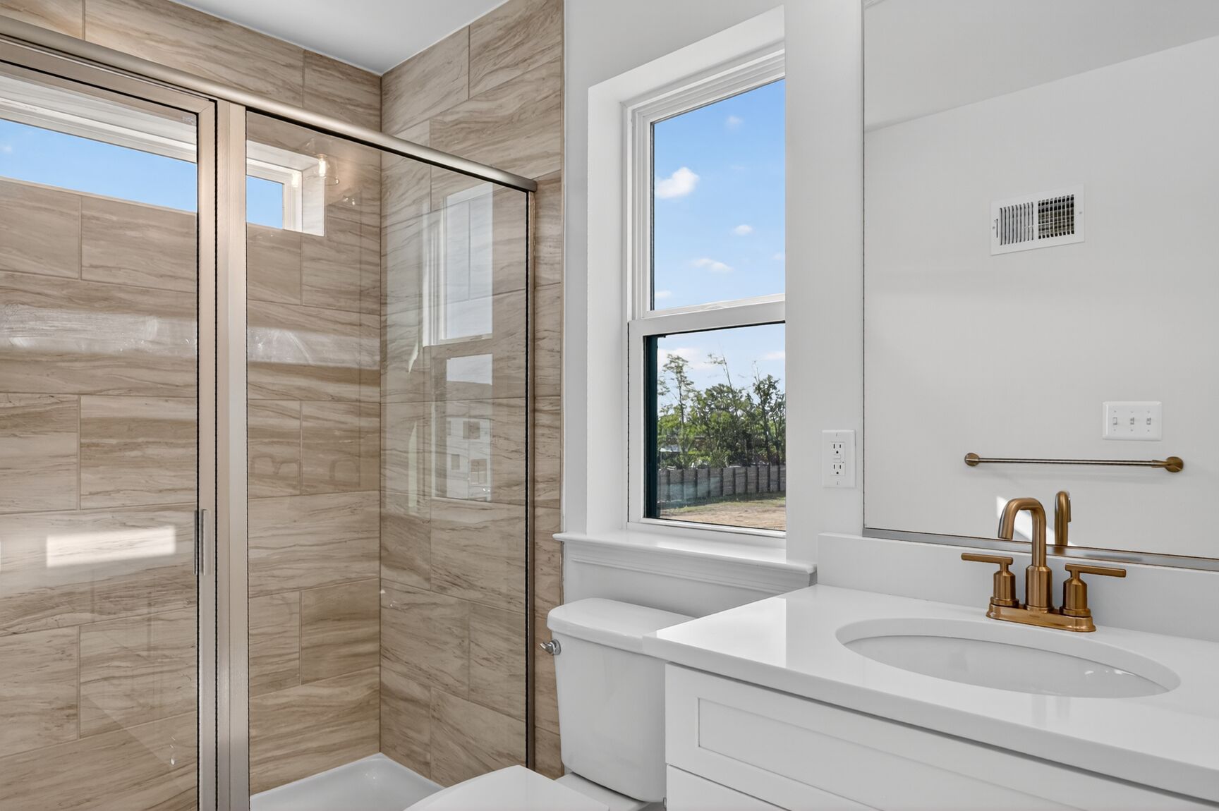 primary bathroom with walk in shower featuring designer tile 