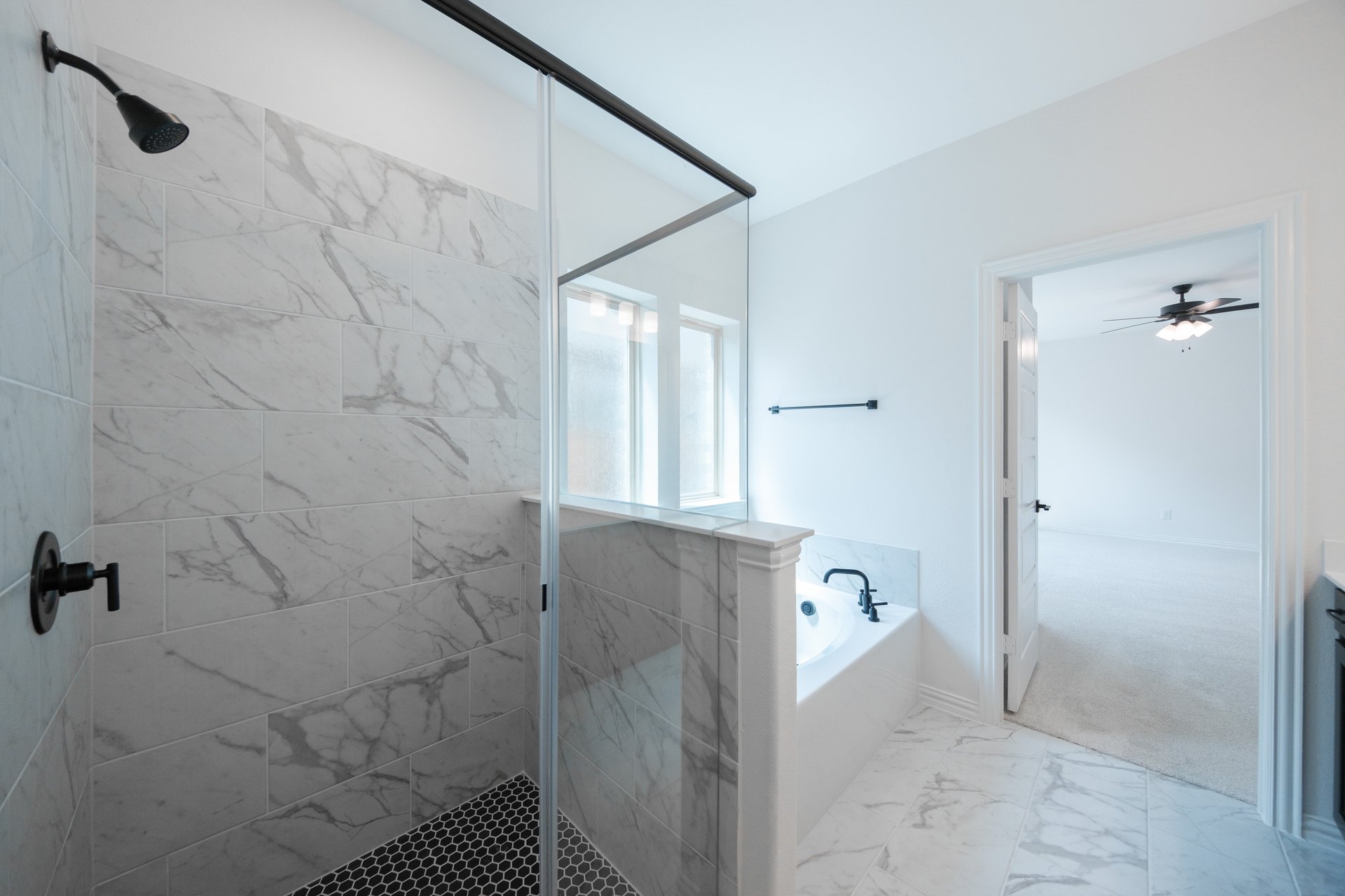 primary bathroom with soaking tub and walk-in shower