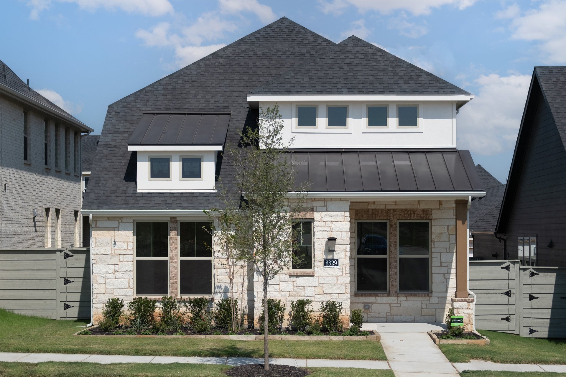 exterior of home with white stone and siding