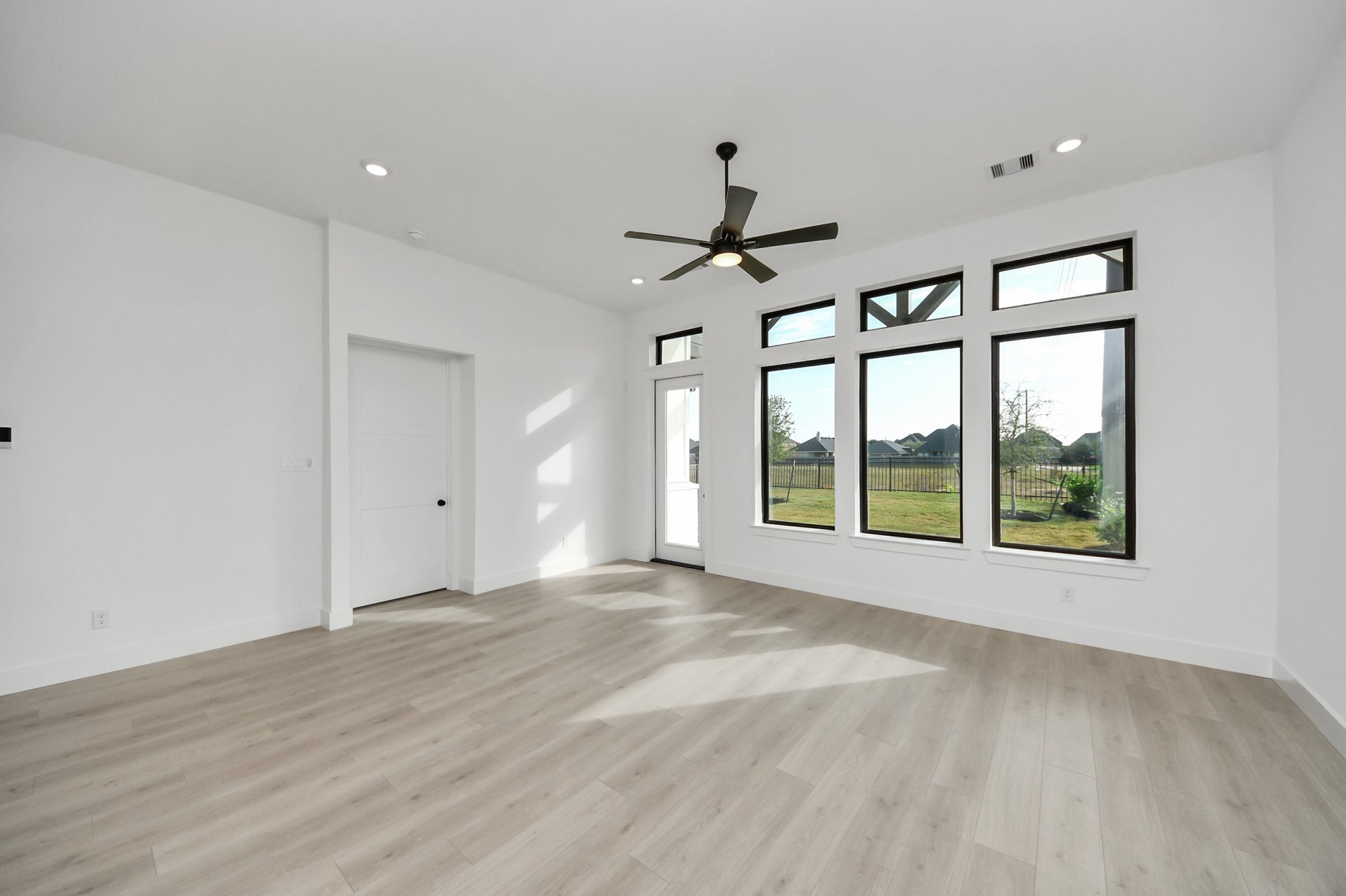 light colored flooring and tall windows