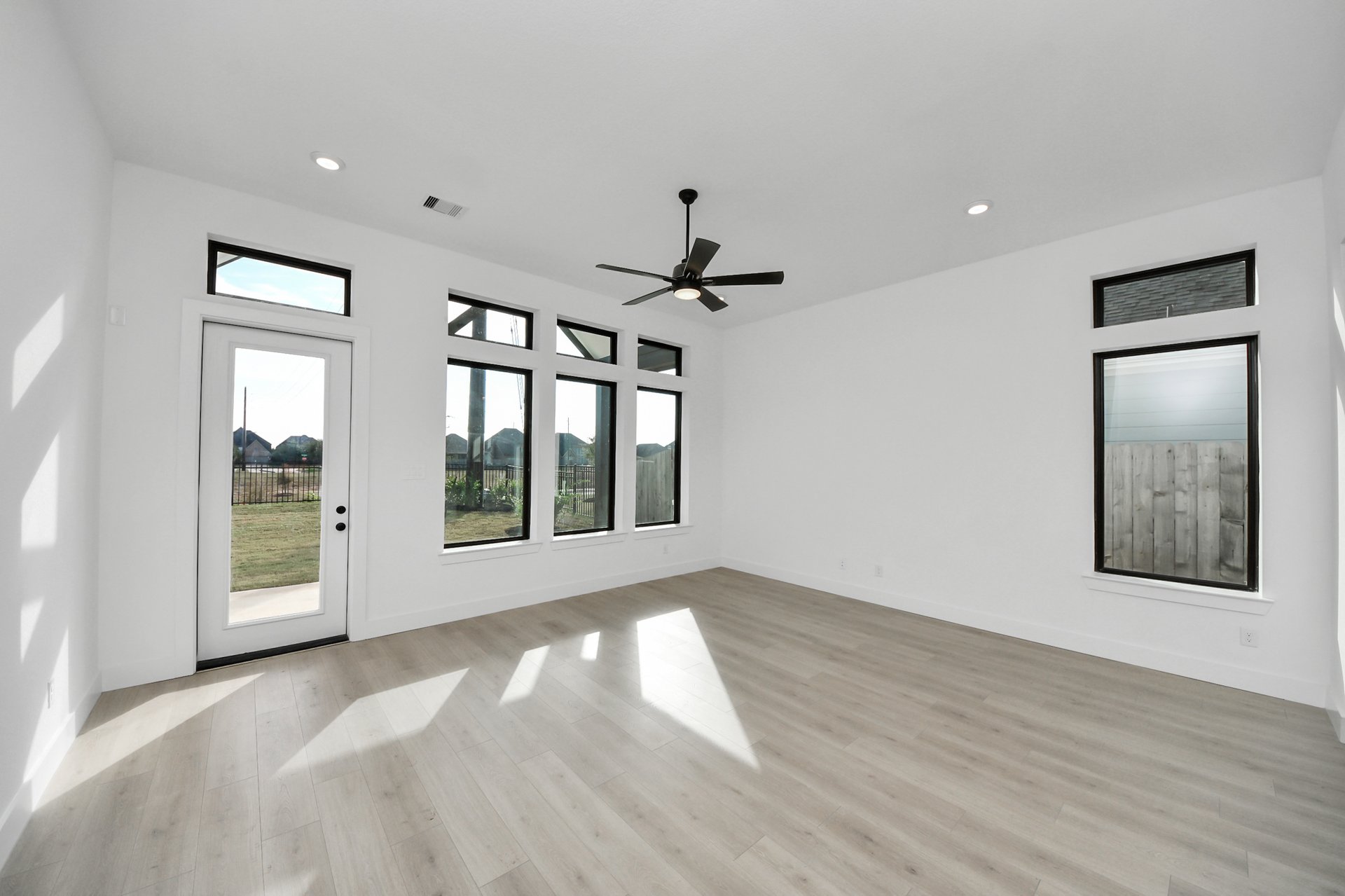 open-concept room with tall ceilings and ceiling fan