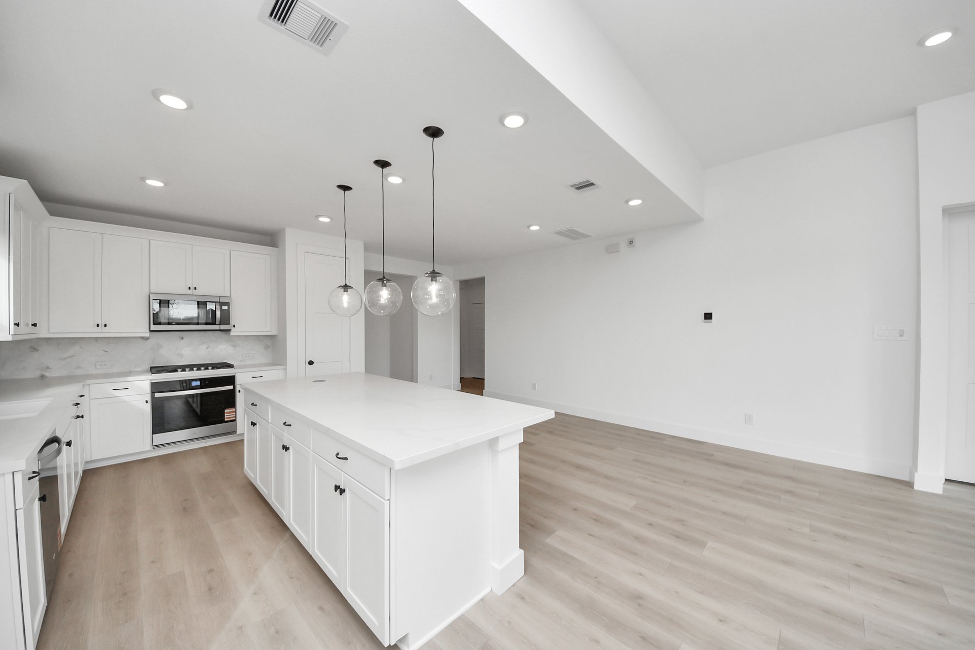 white cabintes and light colored flooring
