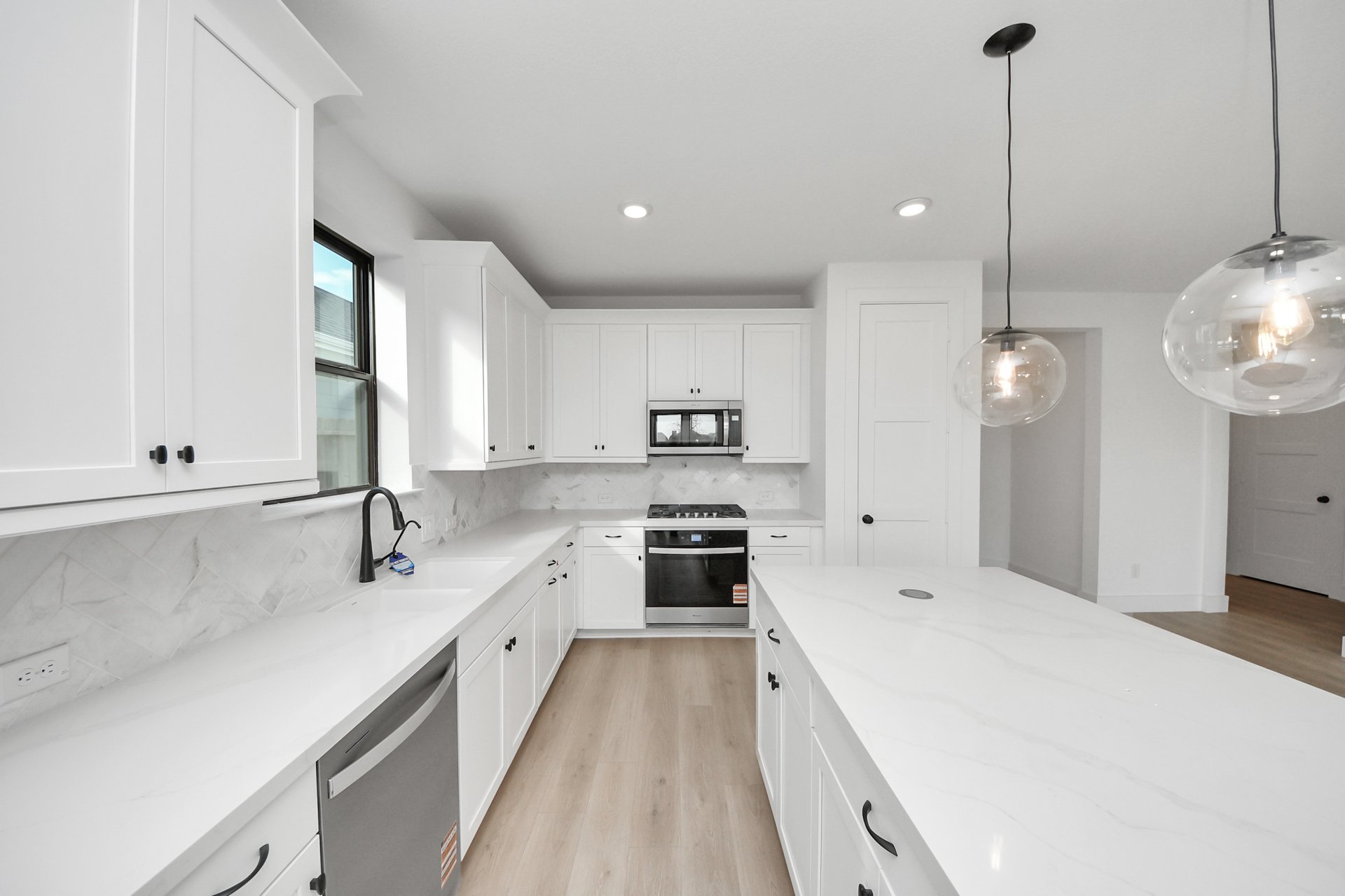 light colored countertops and cabinets with dark hardware