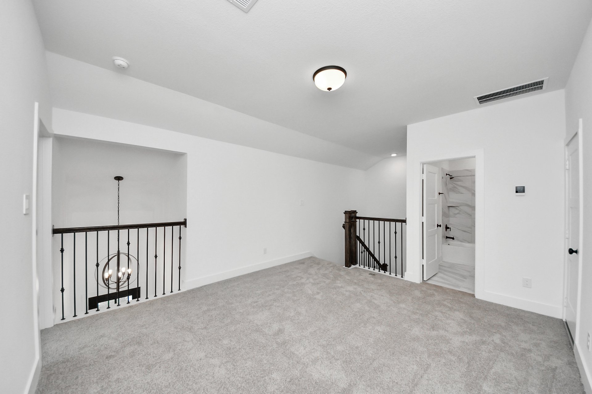 open area with open railing and carpeted floors