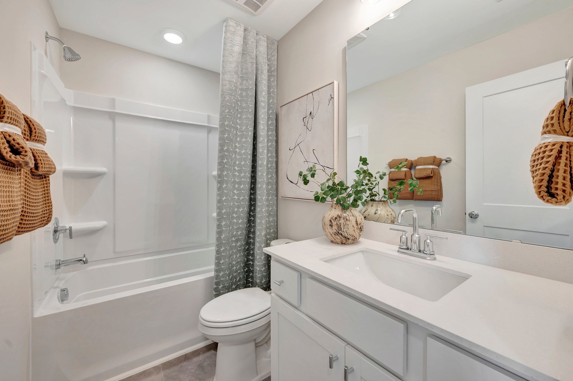 secondary bath with a shower and bathtub combo