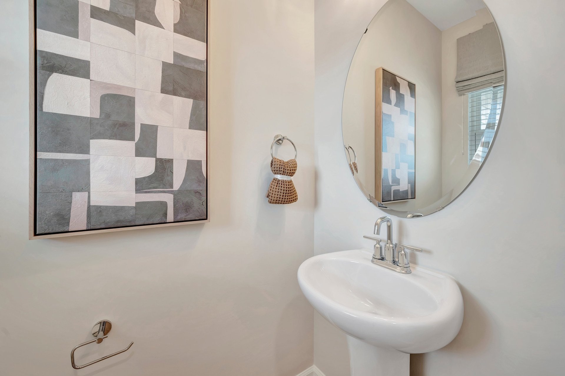 powder room with an oval mirror