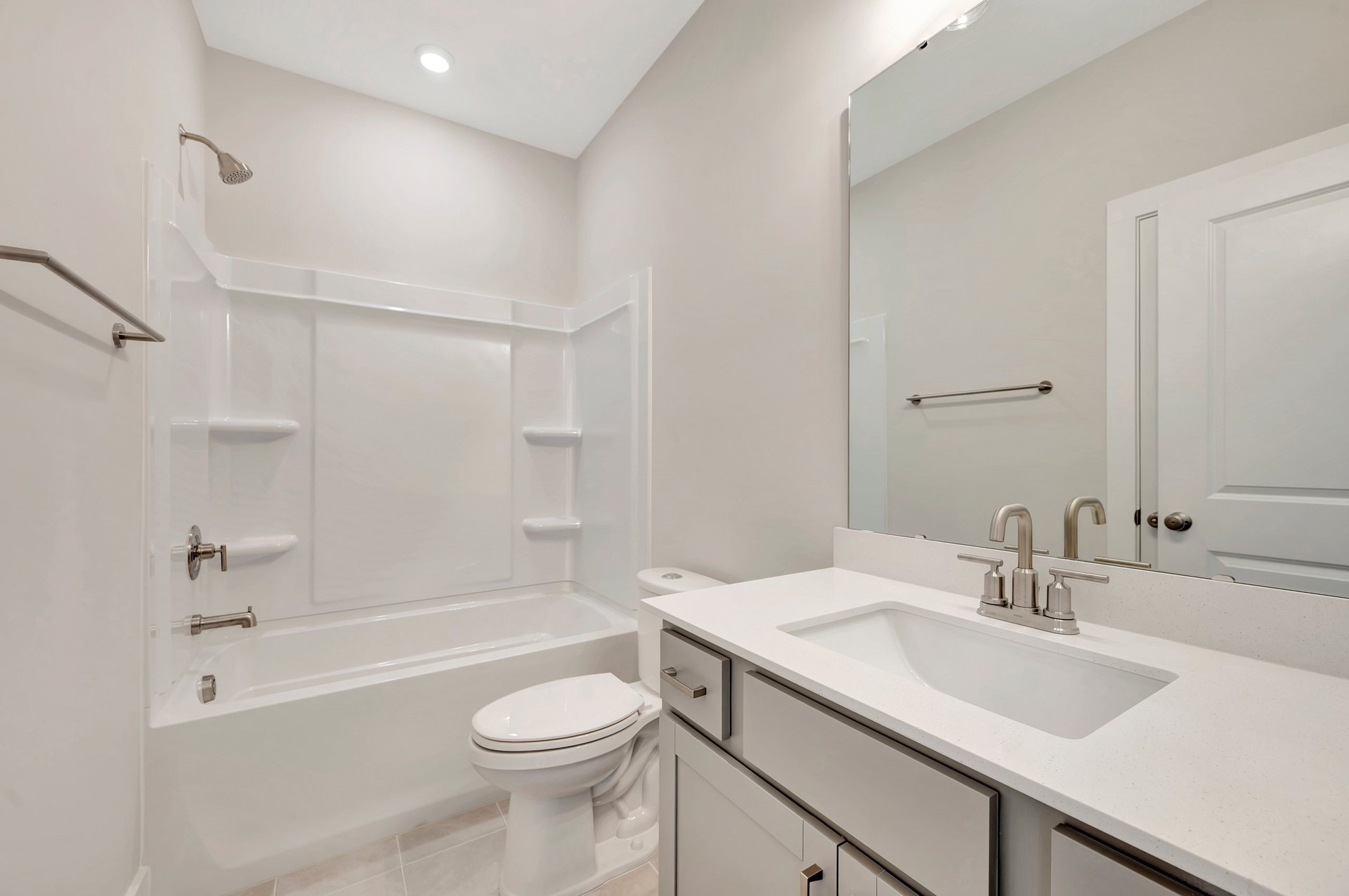 secondary bathroom with a shower and tub combo