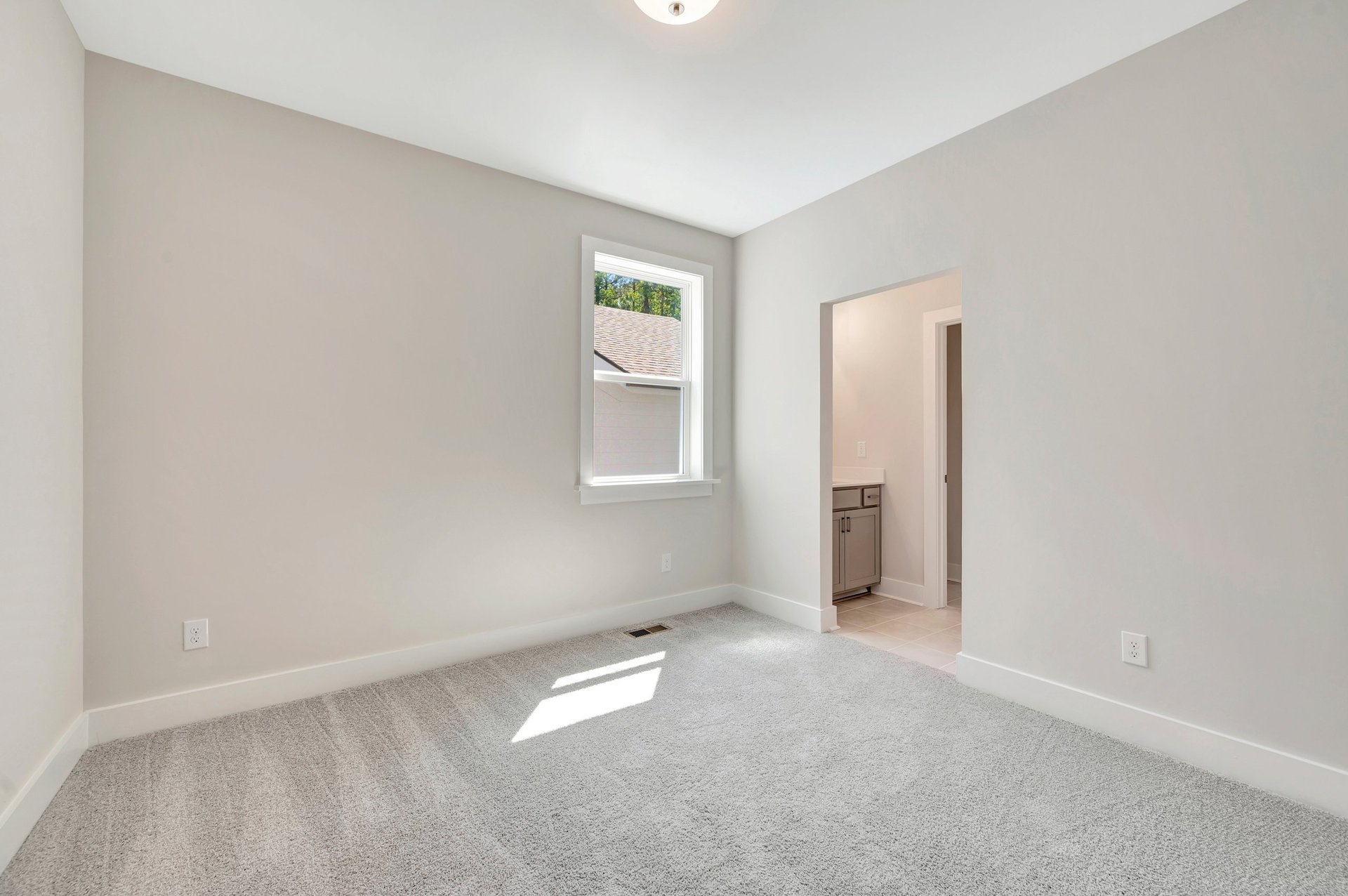 secondary bedroom with a window