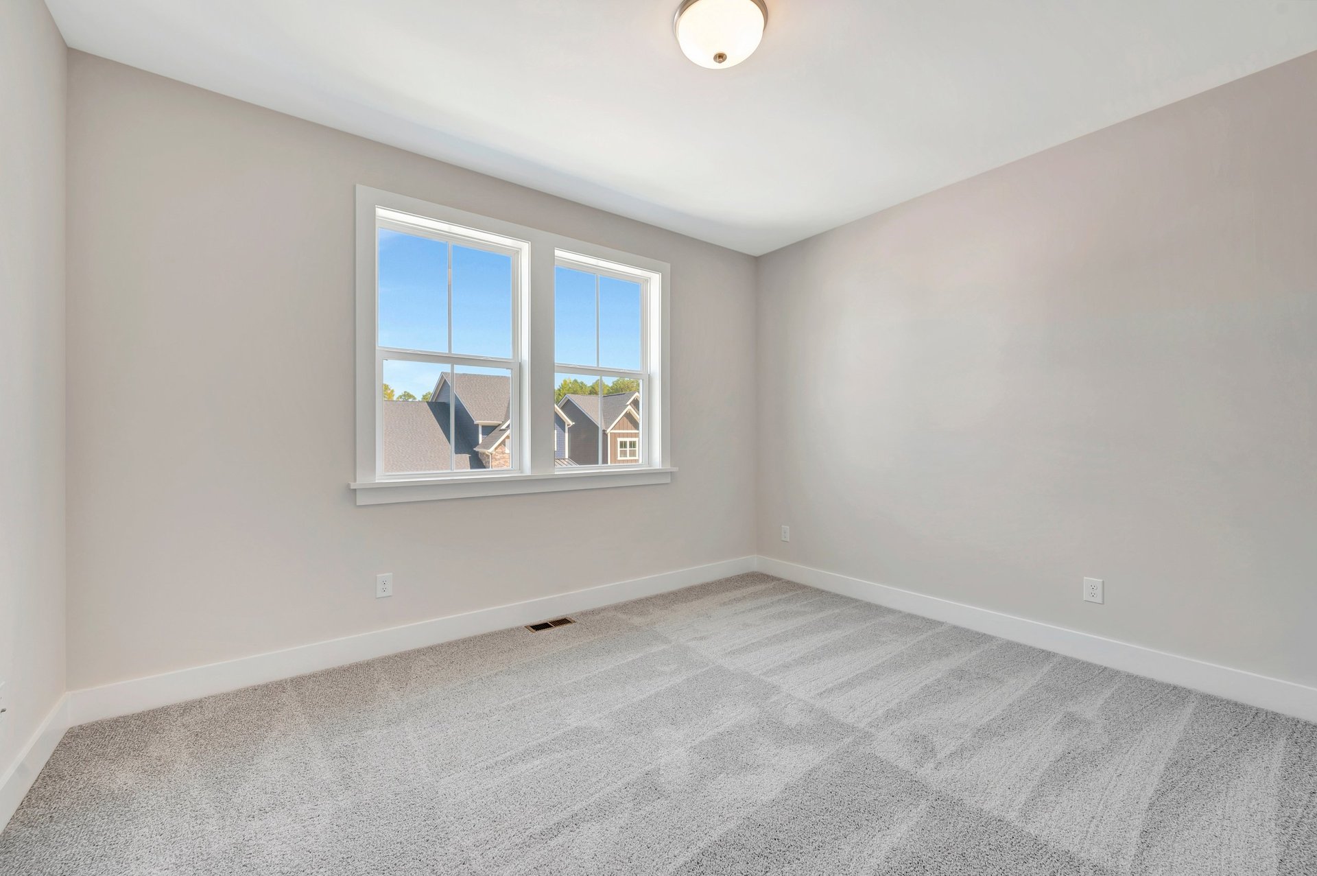 office with two windows and carpet