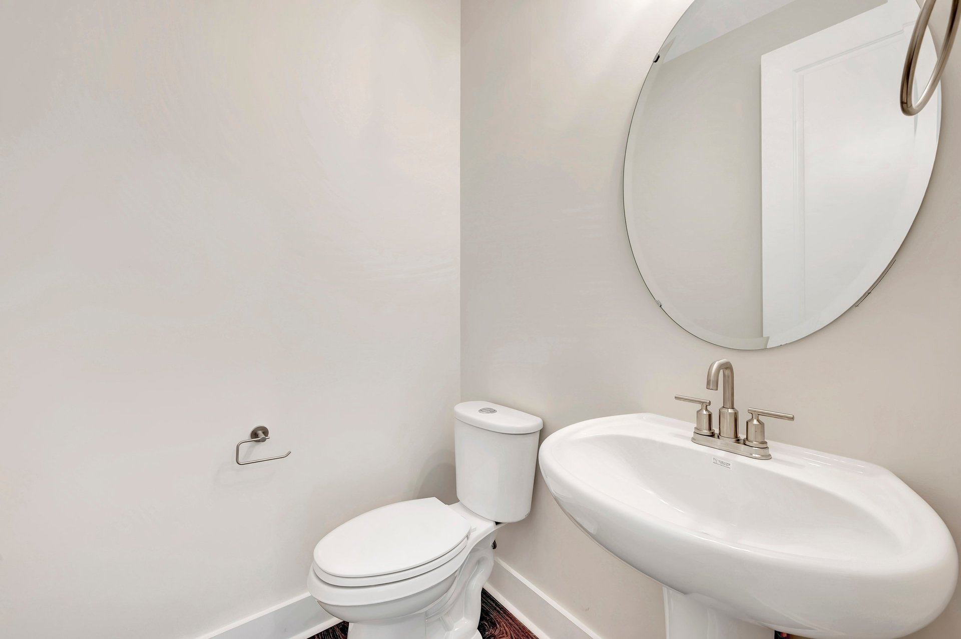 powder room with an oval mirror