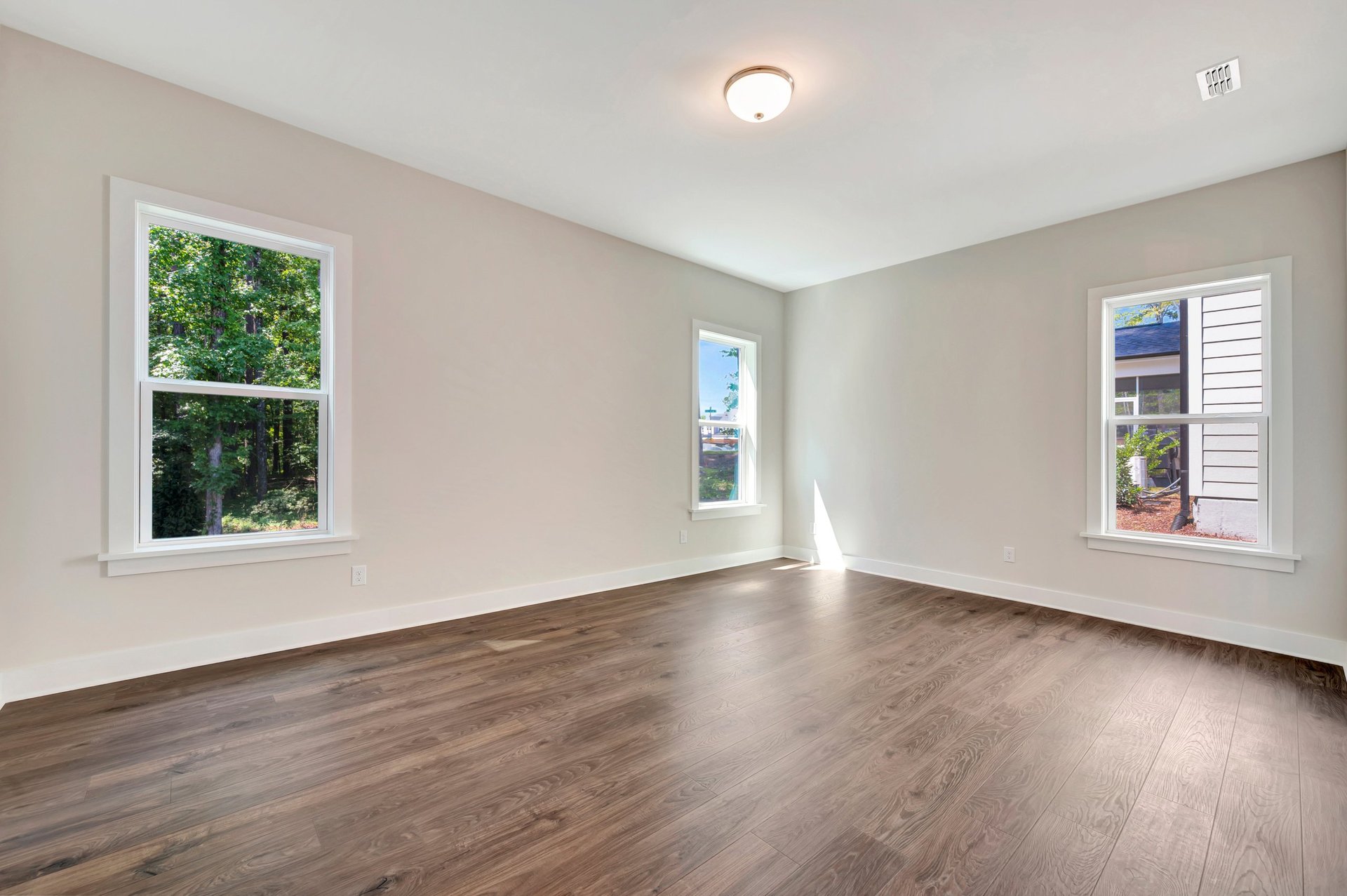 primary bedroom with three windows