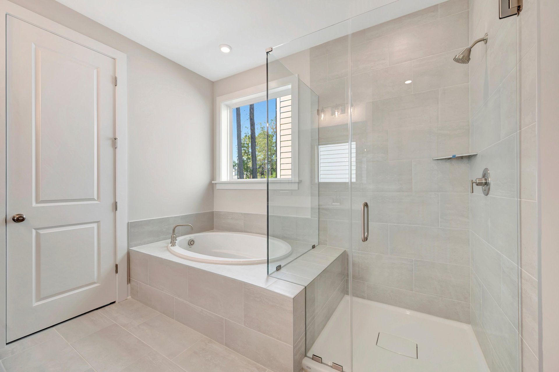 primary bath with a separate tub and shower