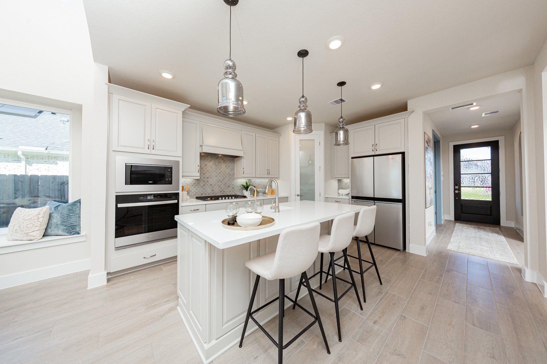 kitchen with white cabinets and pendant lights