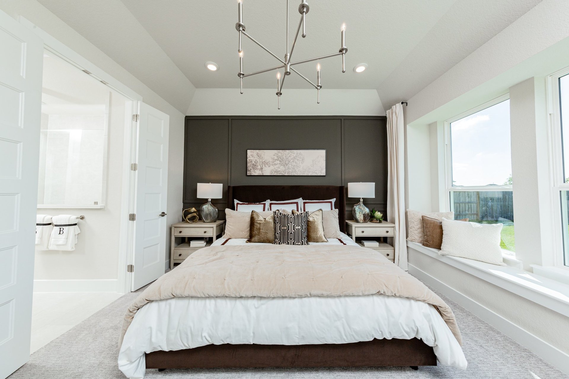 bedroom with 3 windows and chandelier 