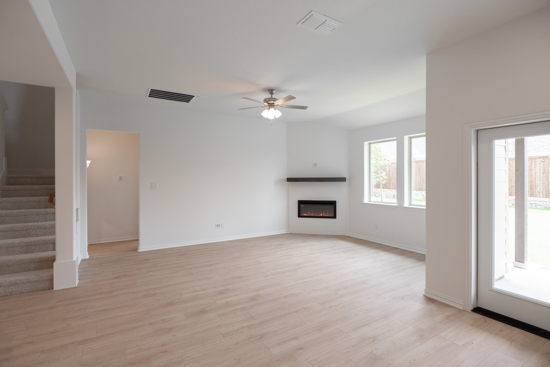 open great room with wood floors and fireplace