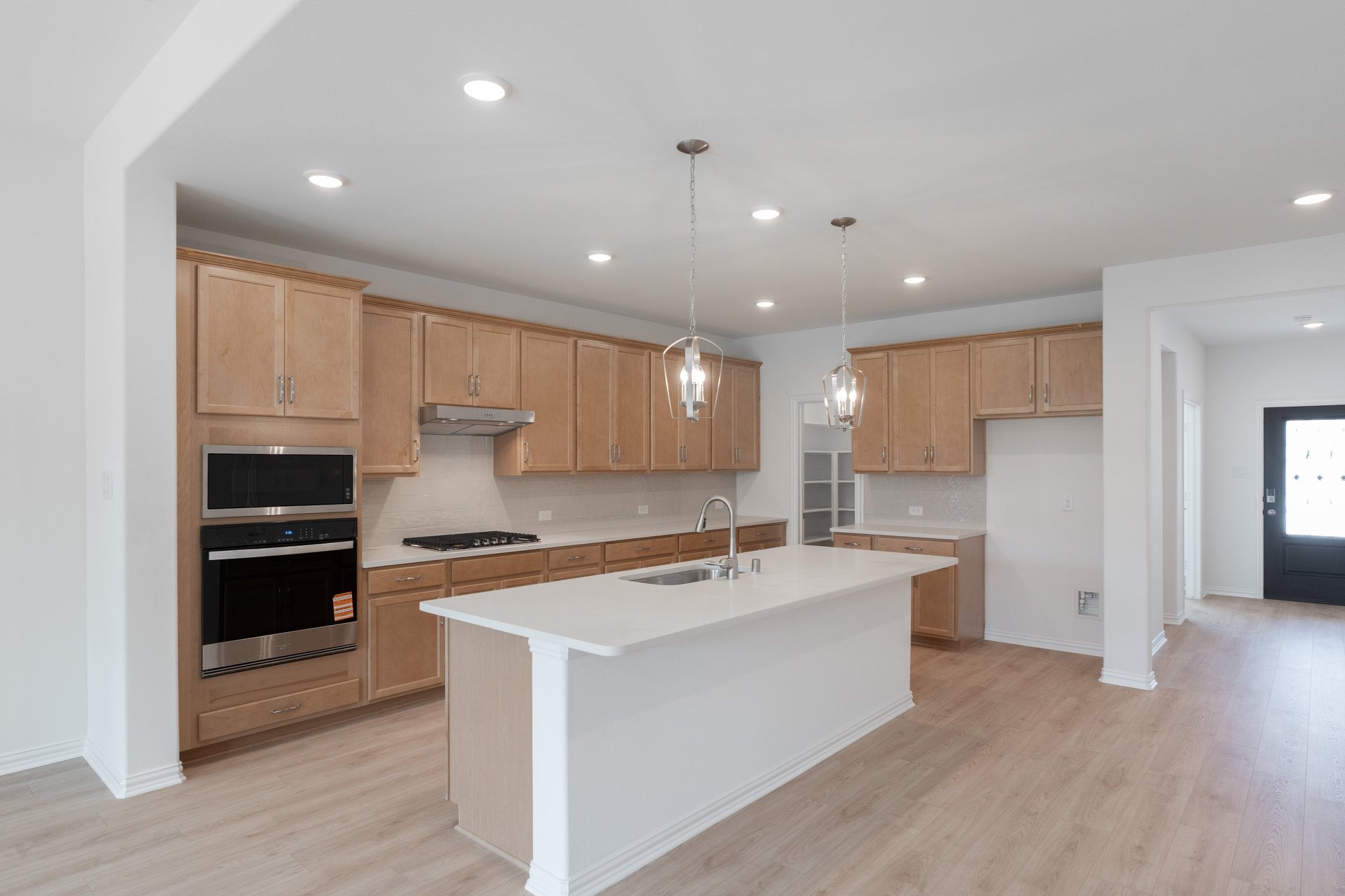 open kitchen with wood floors and island
