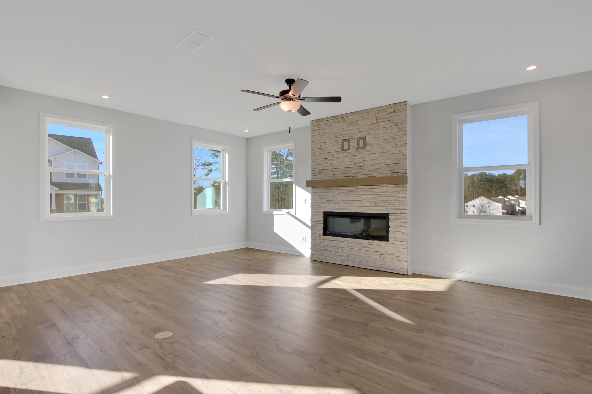 great room with electric fireplace and hard surface flooring