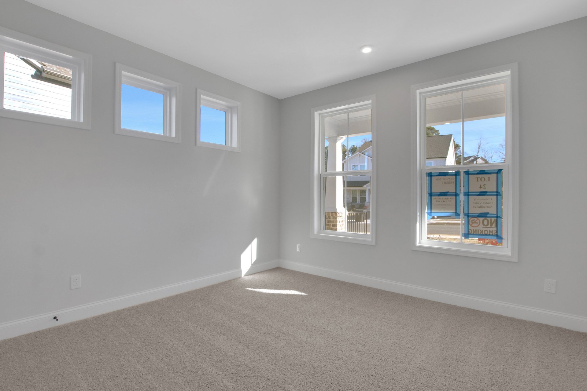 bedroom with lots of windows and carpets