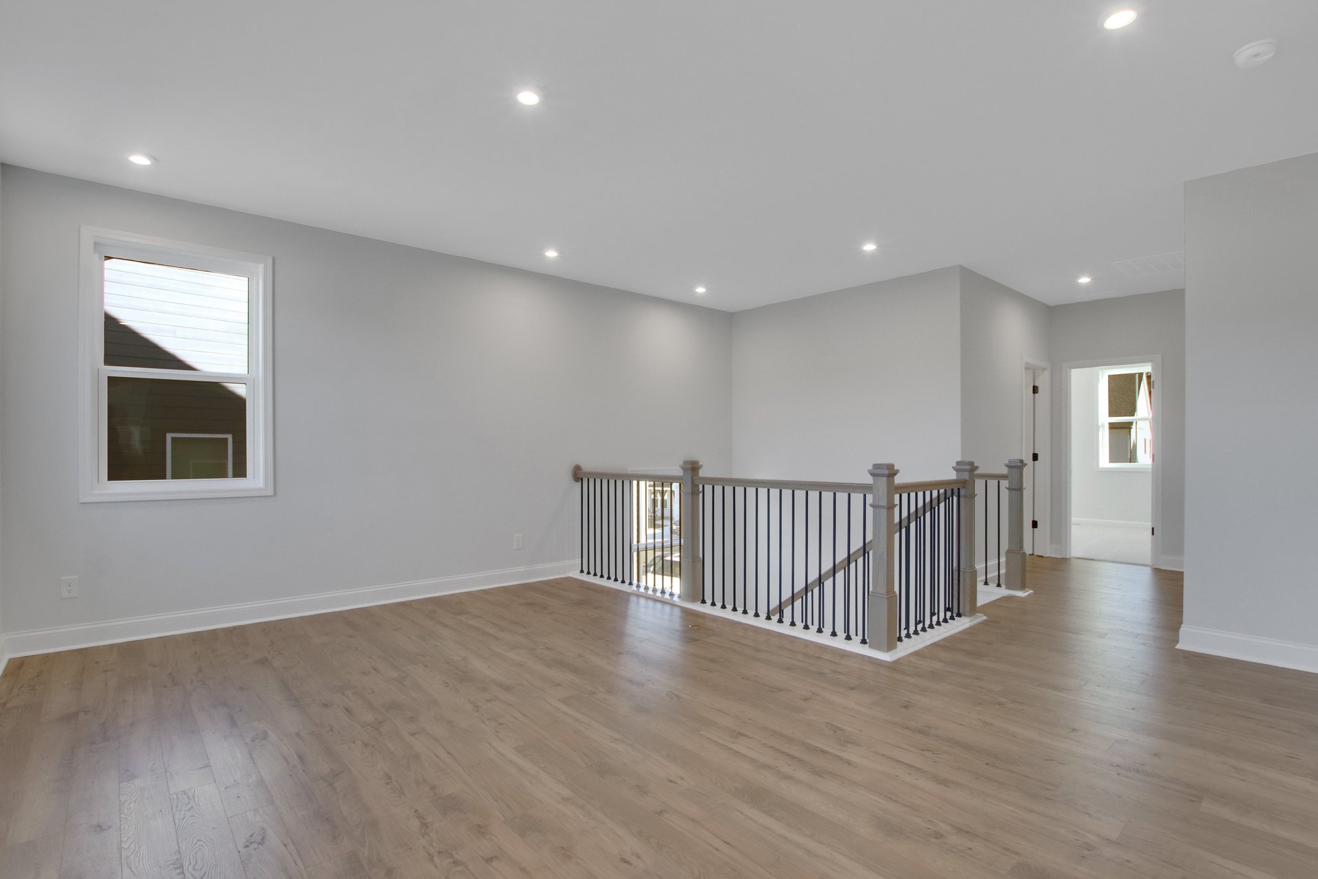loft with hard surface flooring and windows
