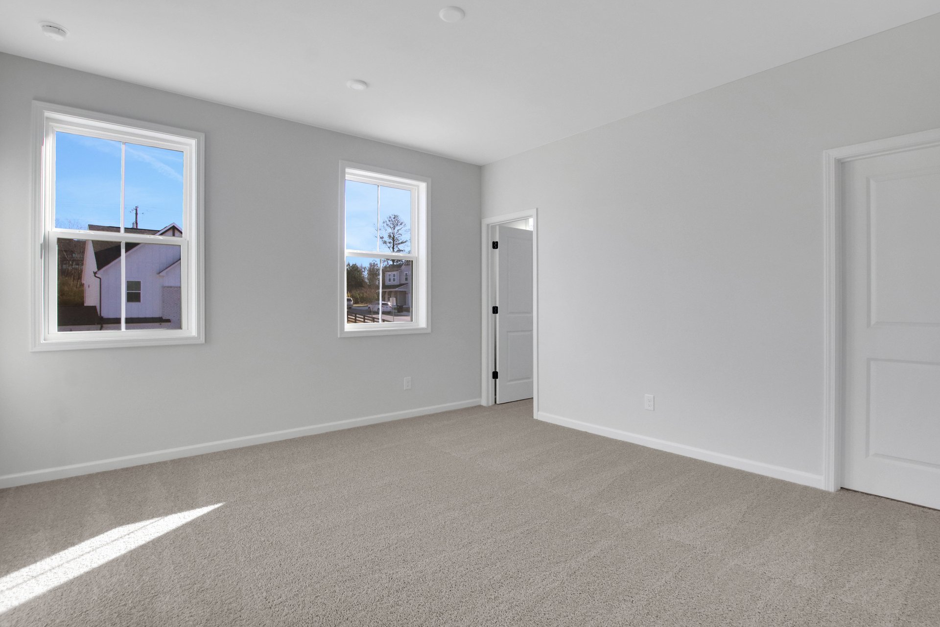 bedroom with windows and carpets