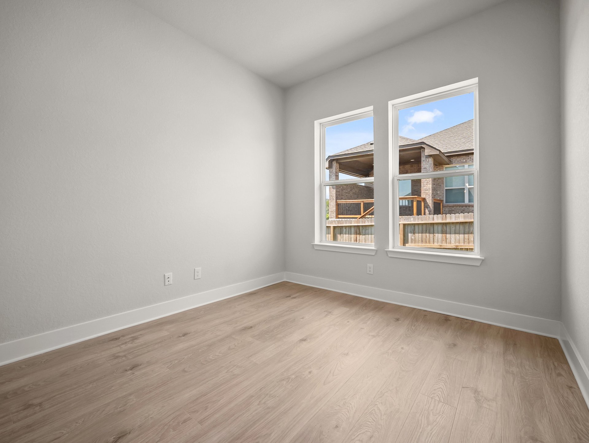 study brown flooring, recessed lighting & a window