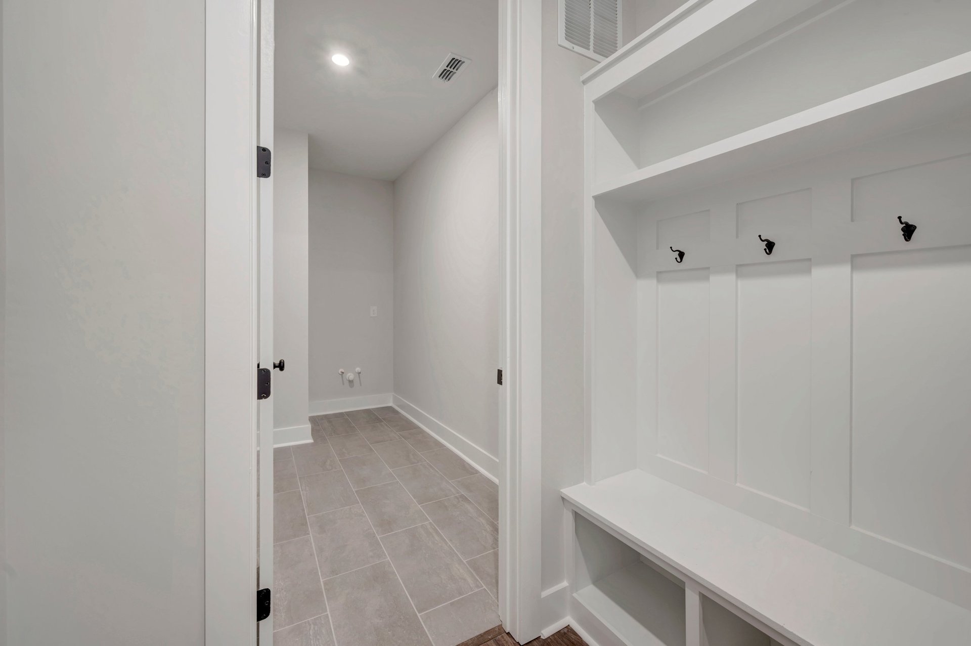 mudroom with a bench with cubbies and hooks