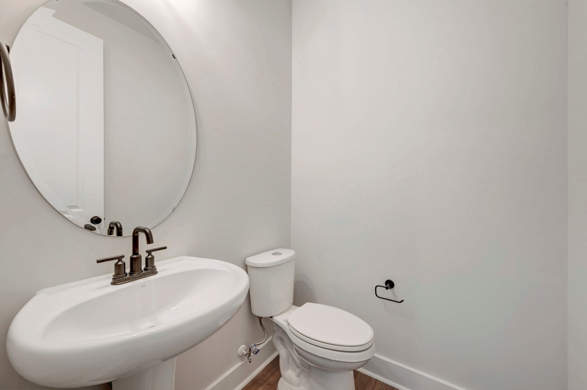powder room with an oval mirror