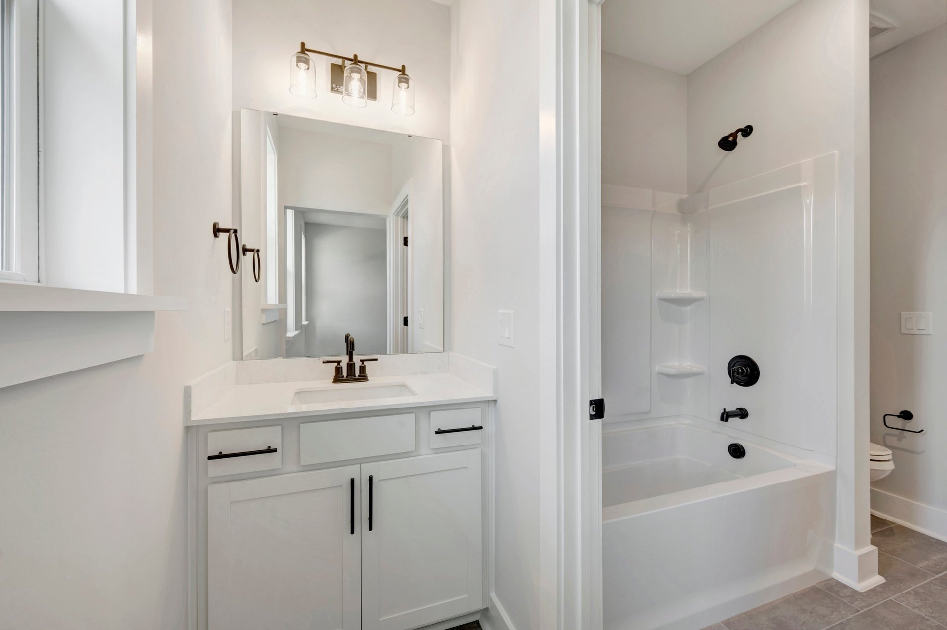 secondary bath with a shower and tub combo