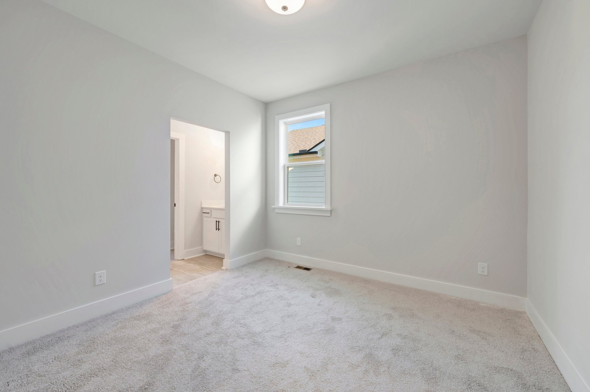 secondary bedroom with a window