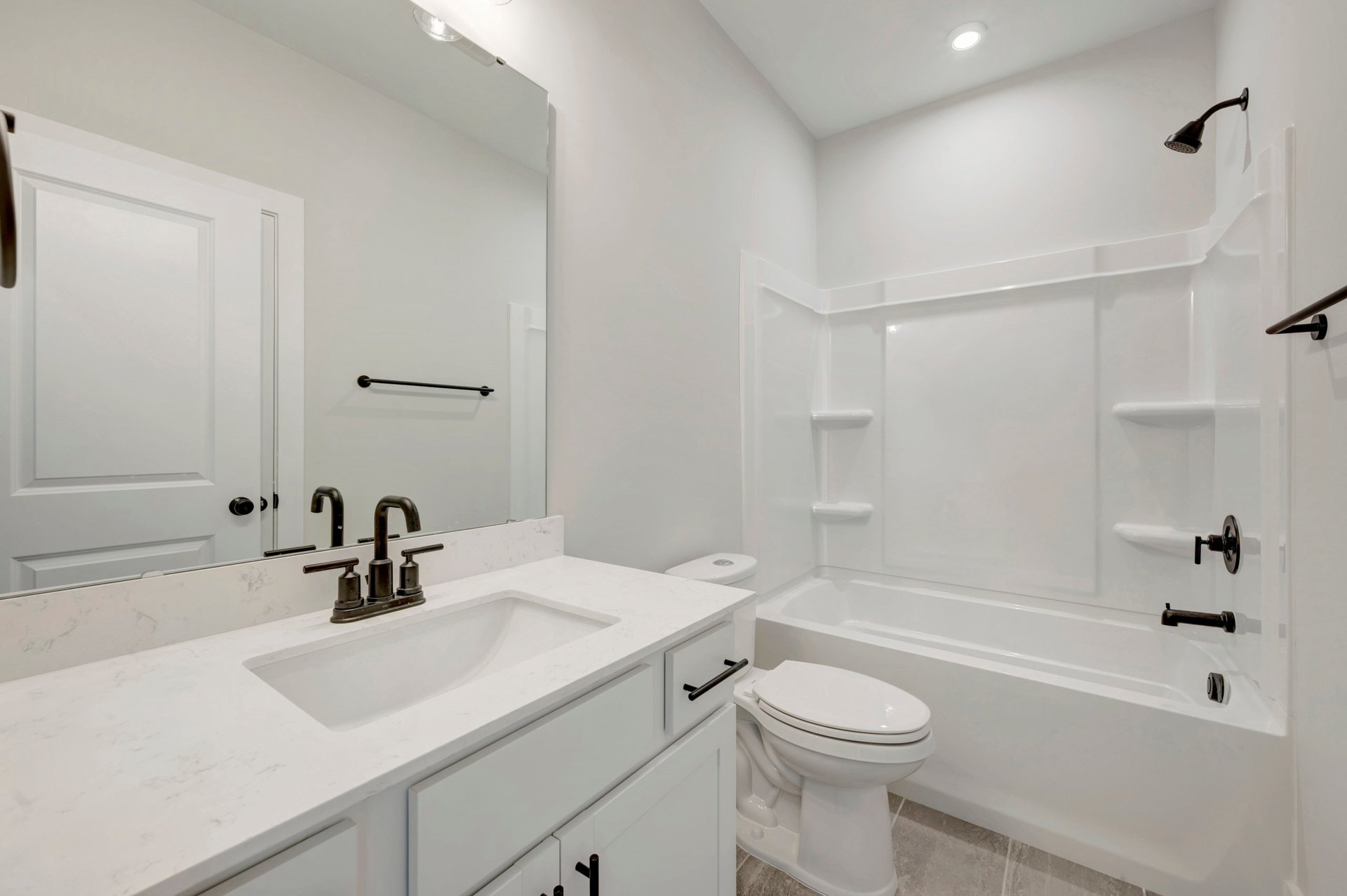 secondary bath with a shower and tub combo