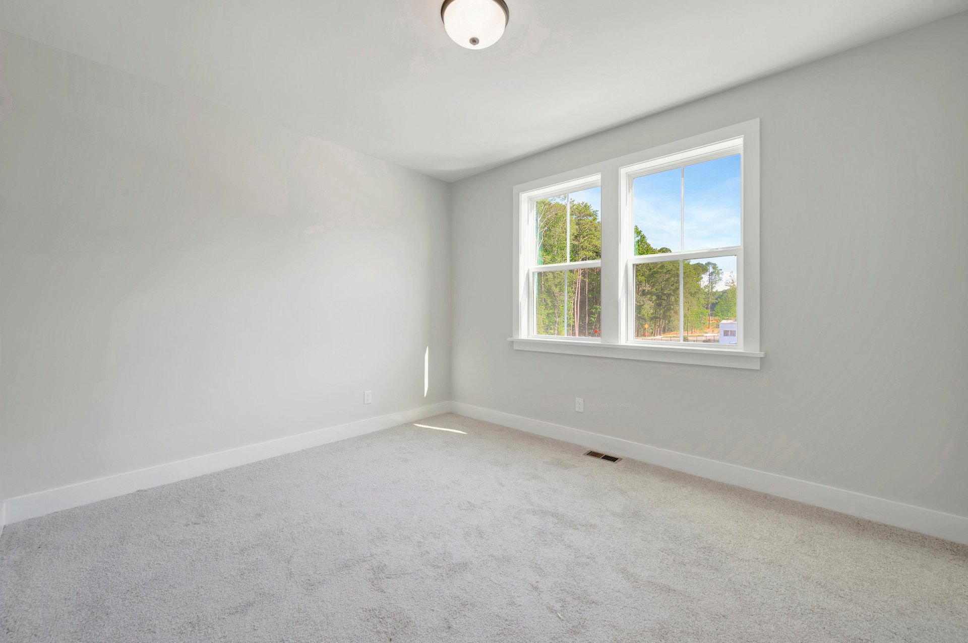 secondary bedroom with two windows