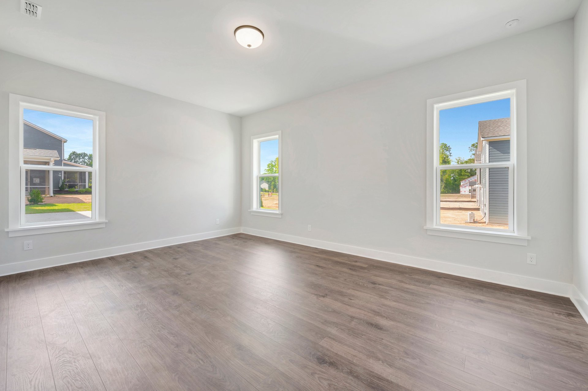 primary bedroom with three windows