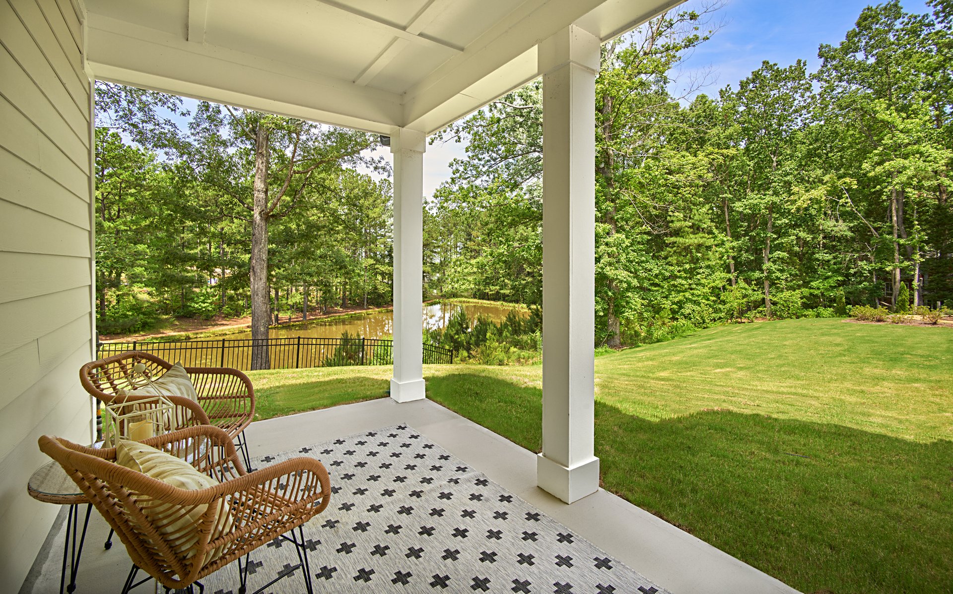covered patio with two chairs