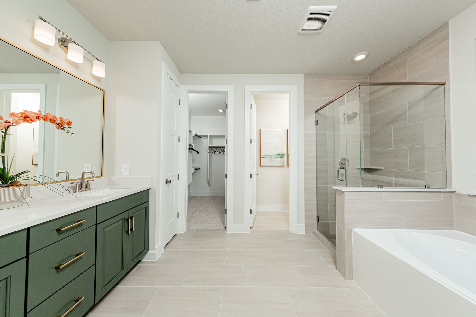 bathroom with green cabinet vanity