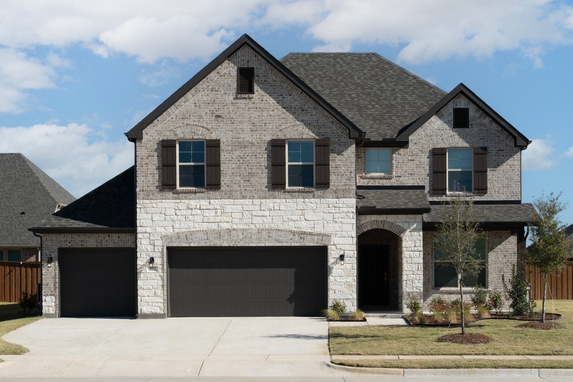 exterior of home with brown brick and white stone