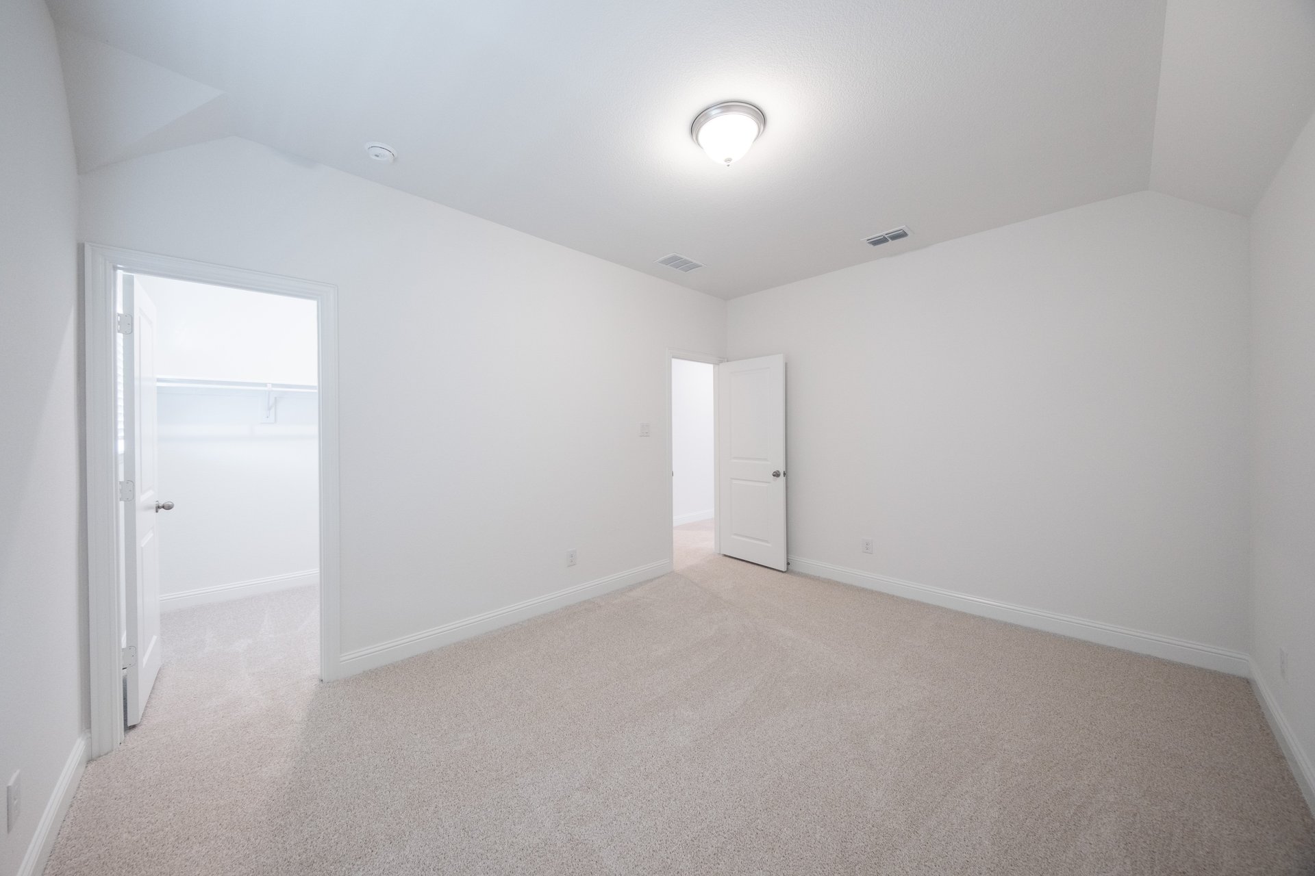 guest bedroom with carpet and window