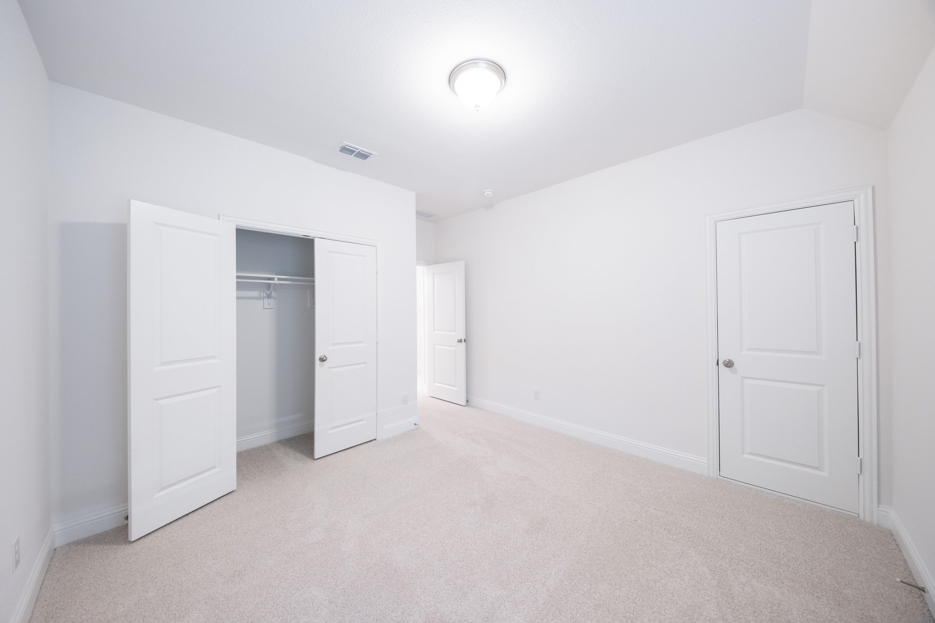guest bedroom with carpet and window