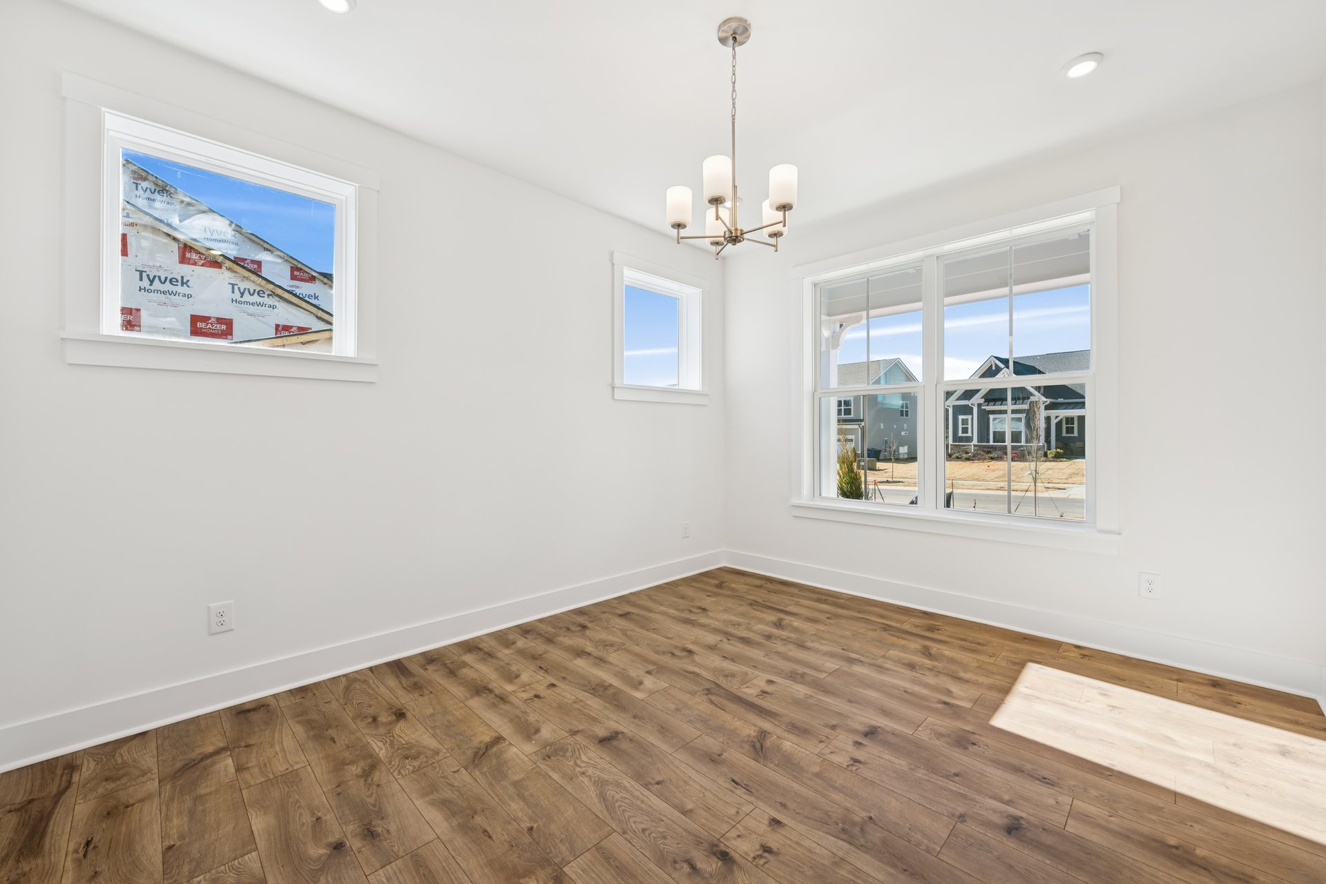 dining room with multiple windows and a light fixture
