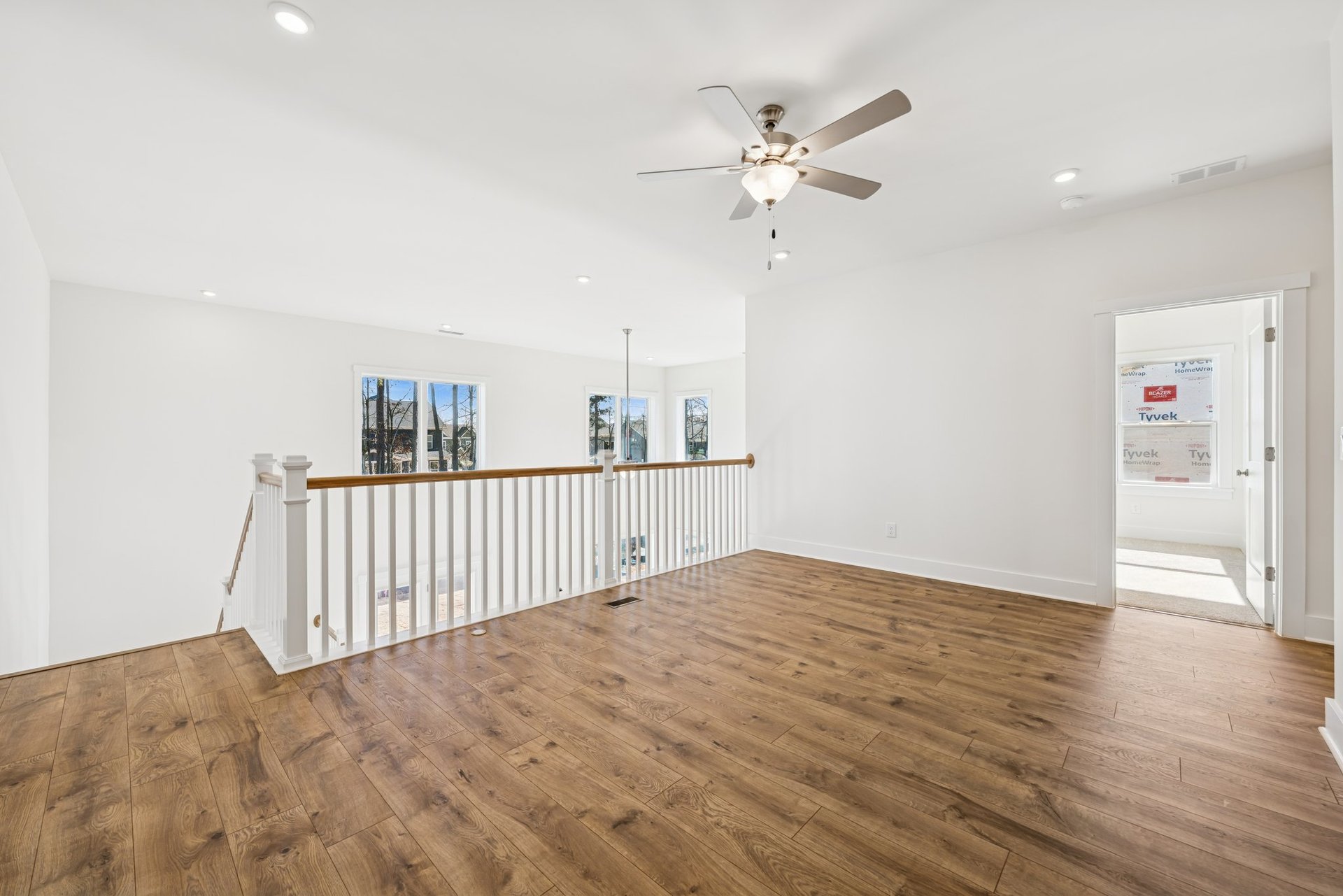 loft with a ceiling fan and access to the secondary bedrooms