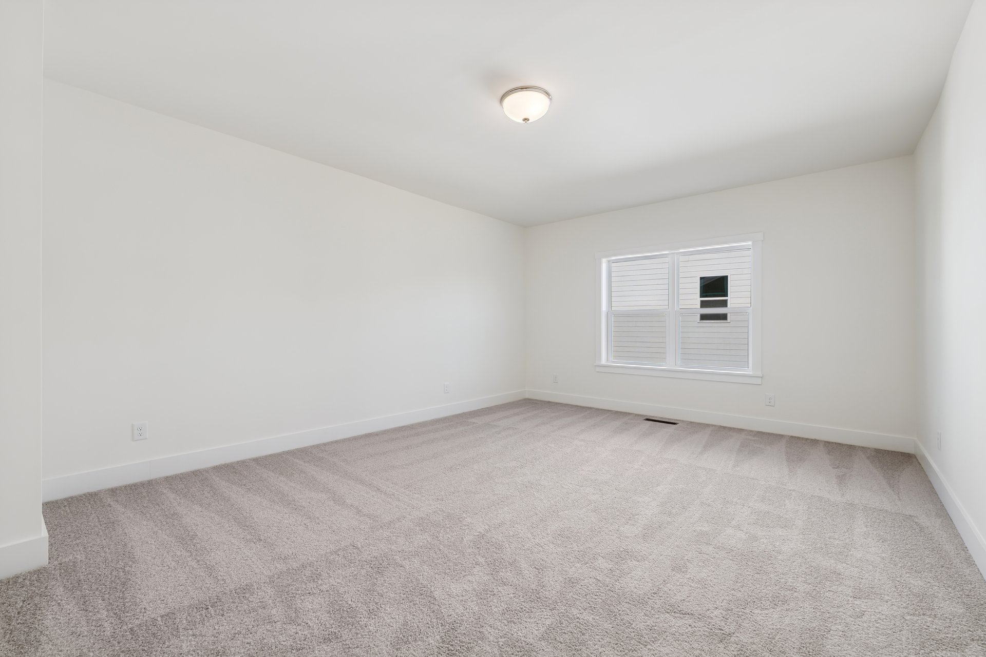 carpeted bonus room with two windows