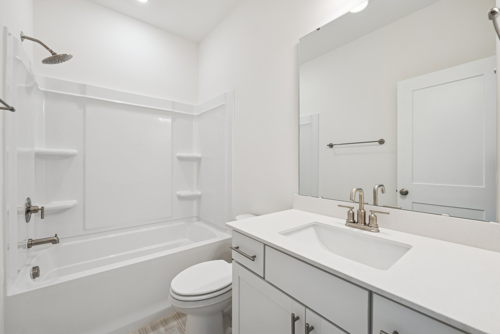 secondary bathroom with a tub and shower combo