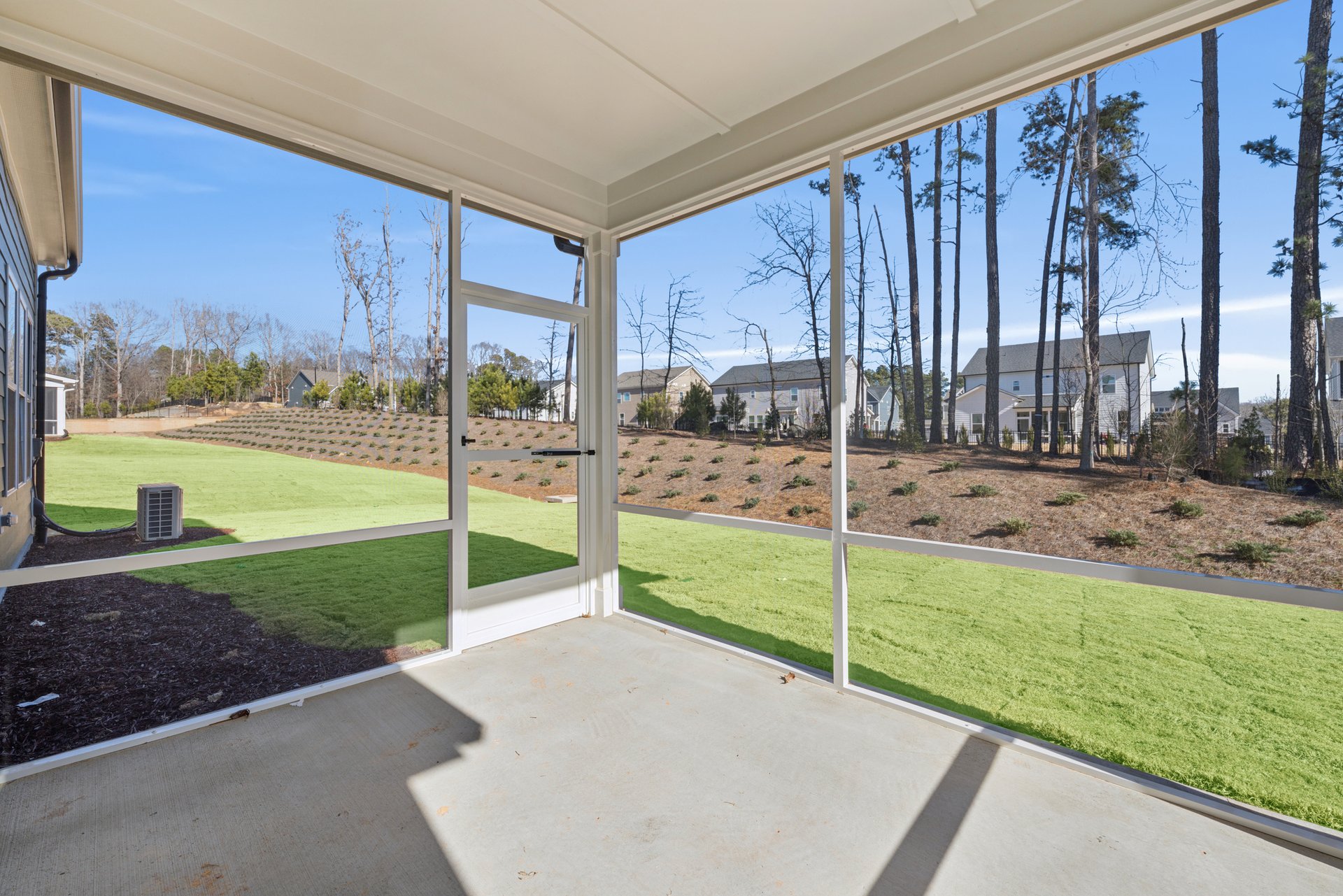 screened porch with view of backyard