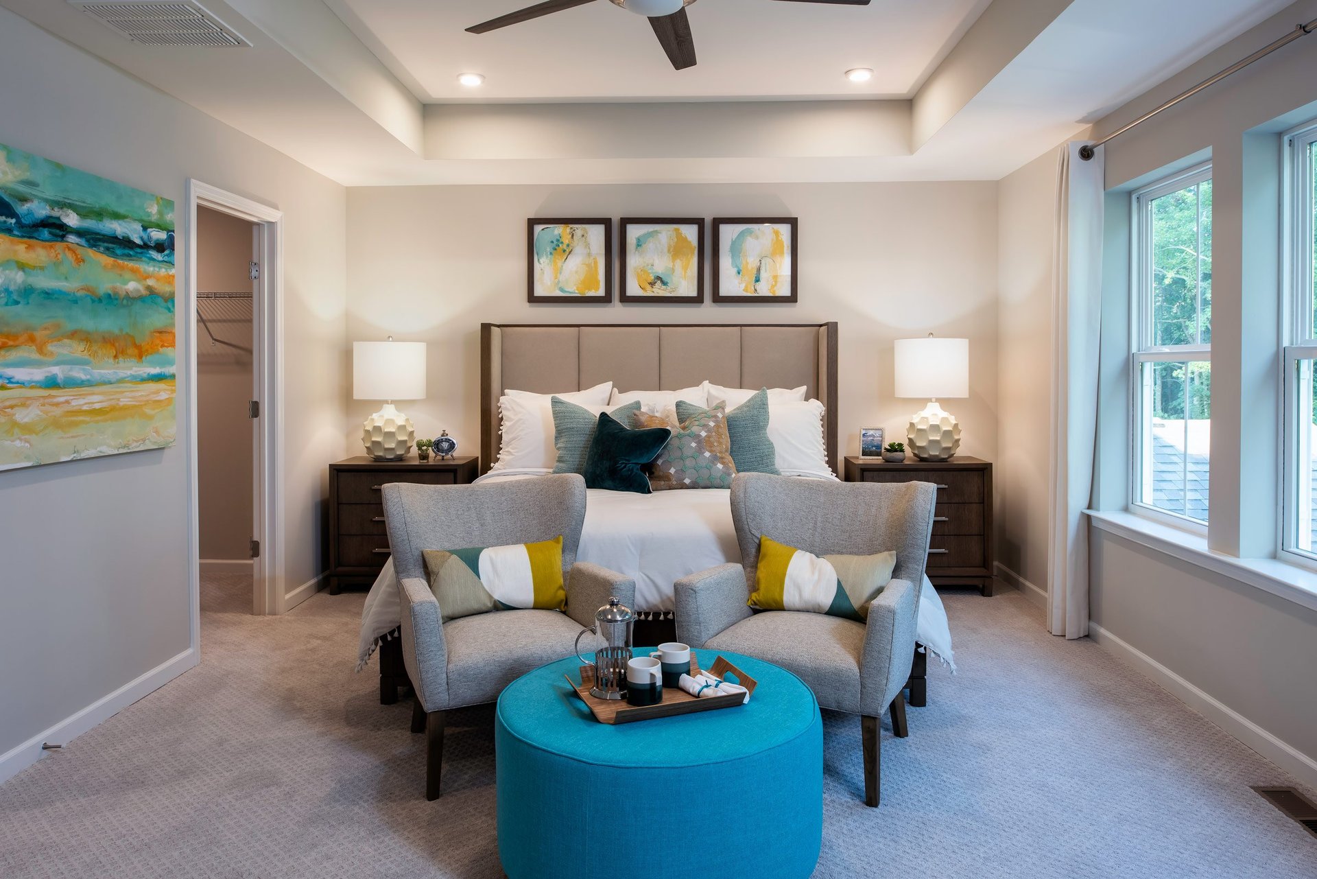 primary suite with a box ceiling and carpet