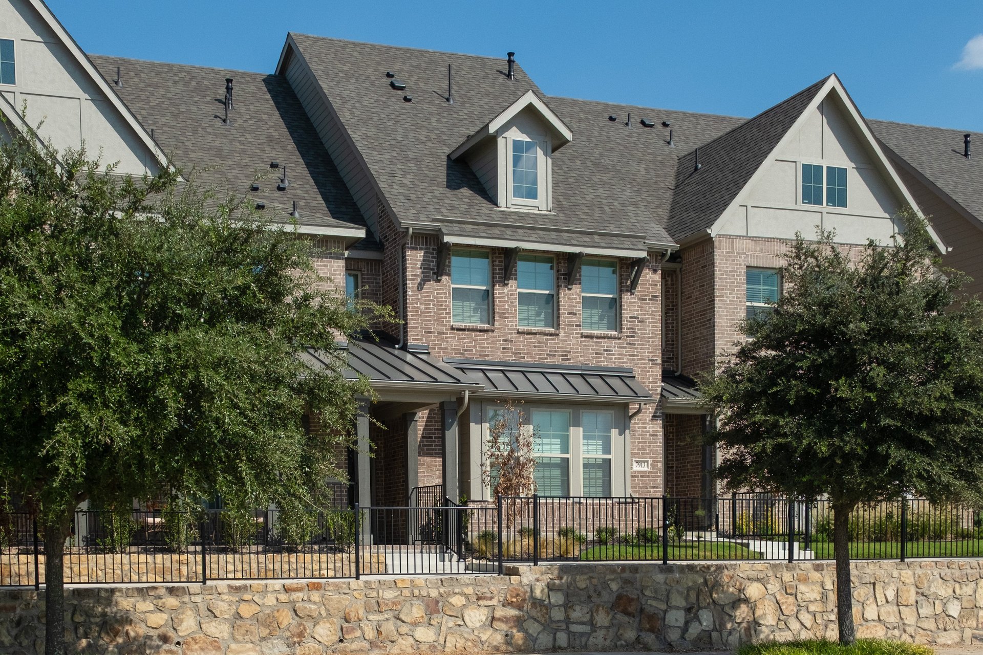 exterior of home with brick and covered porch