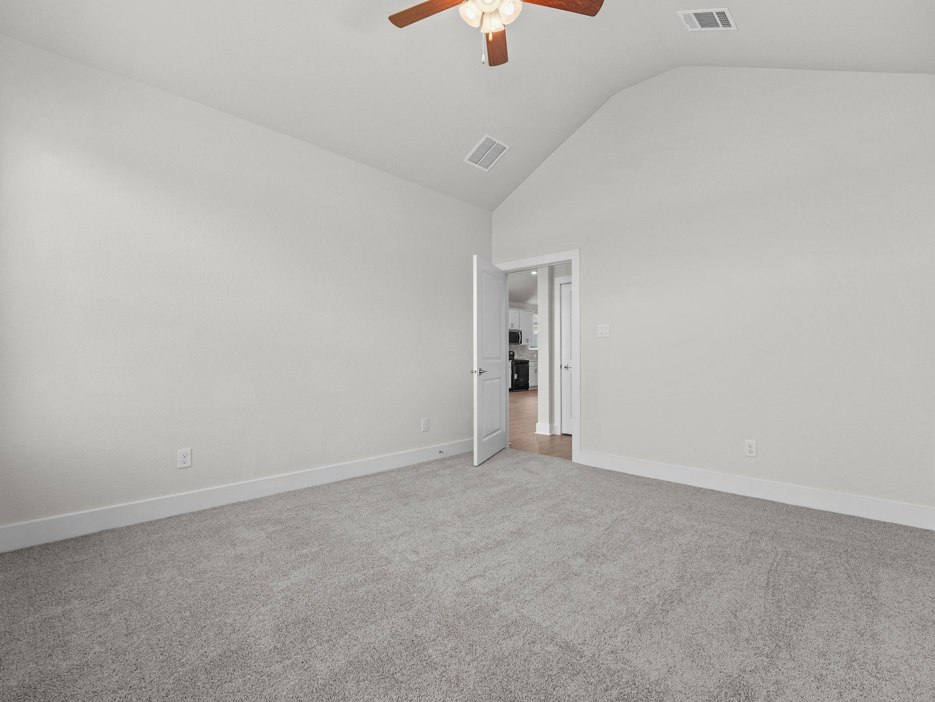 primary bedroom with windows, ceiling fan and carpet