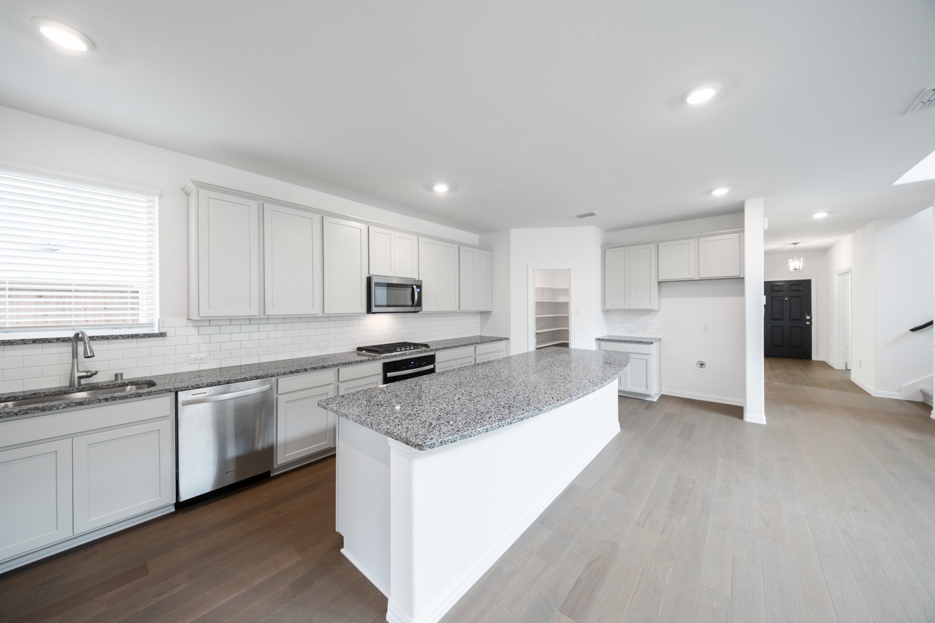 open kitchen with white cabinets