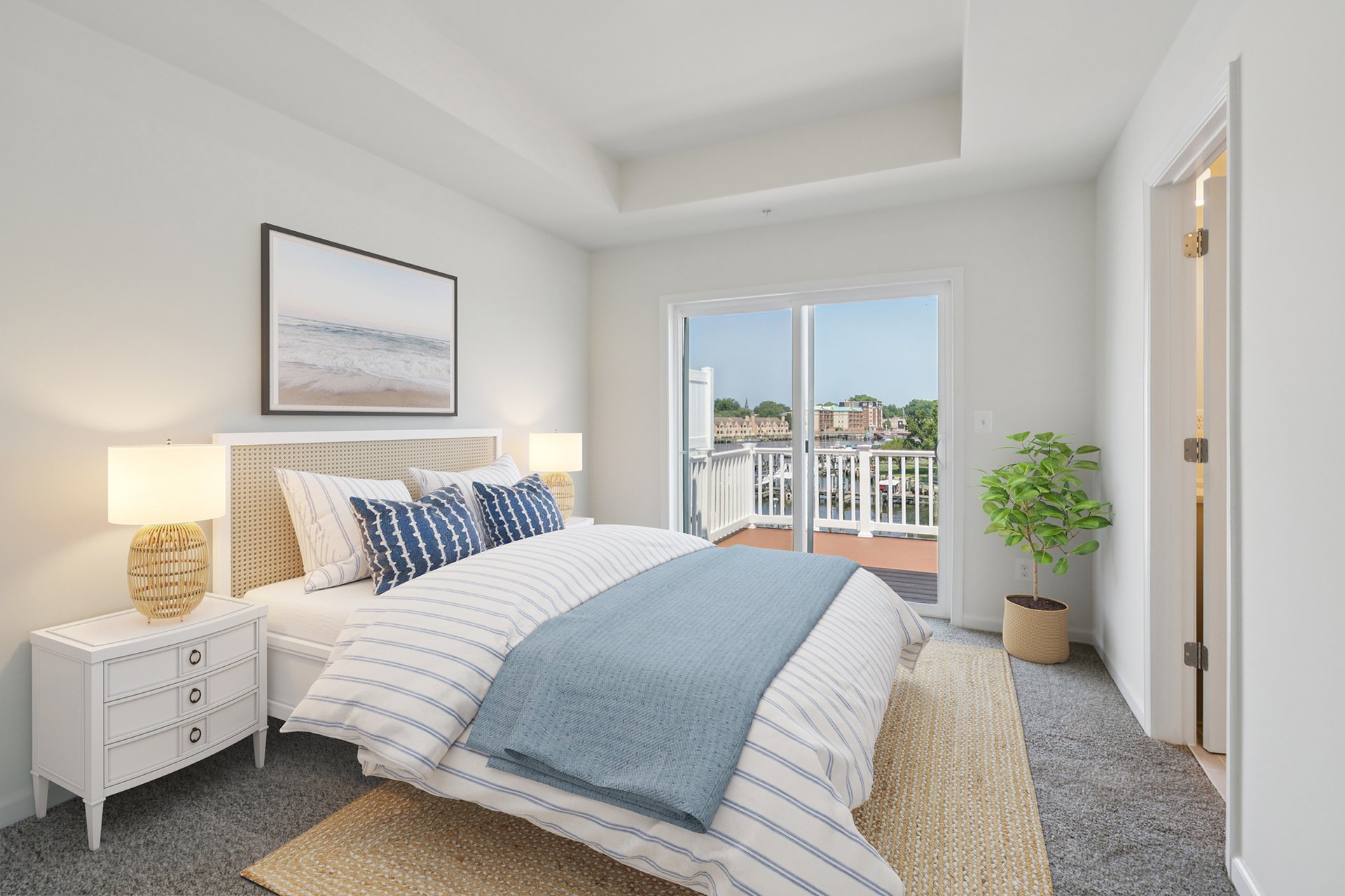 primary suite with a box cieling with carpet