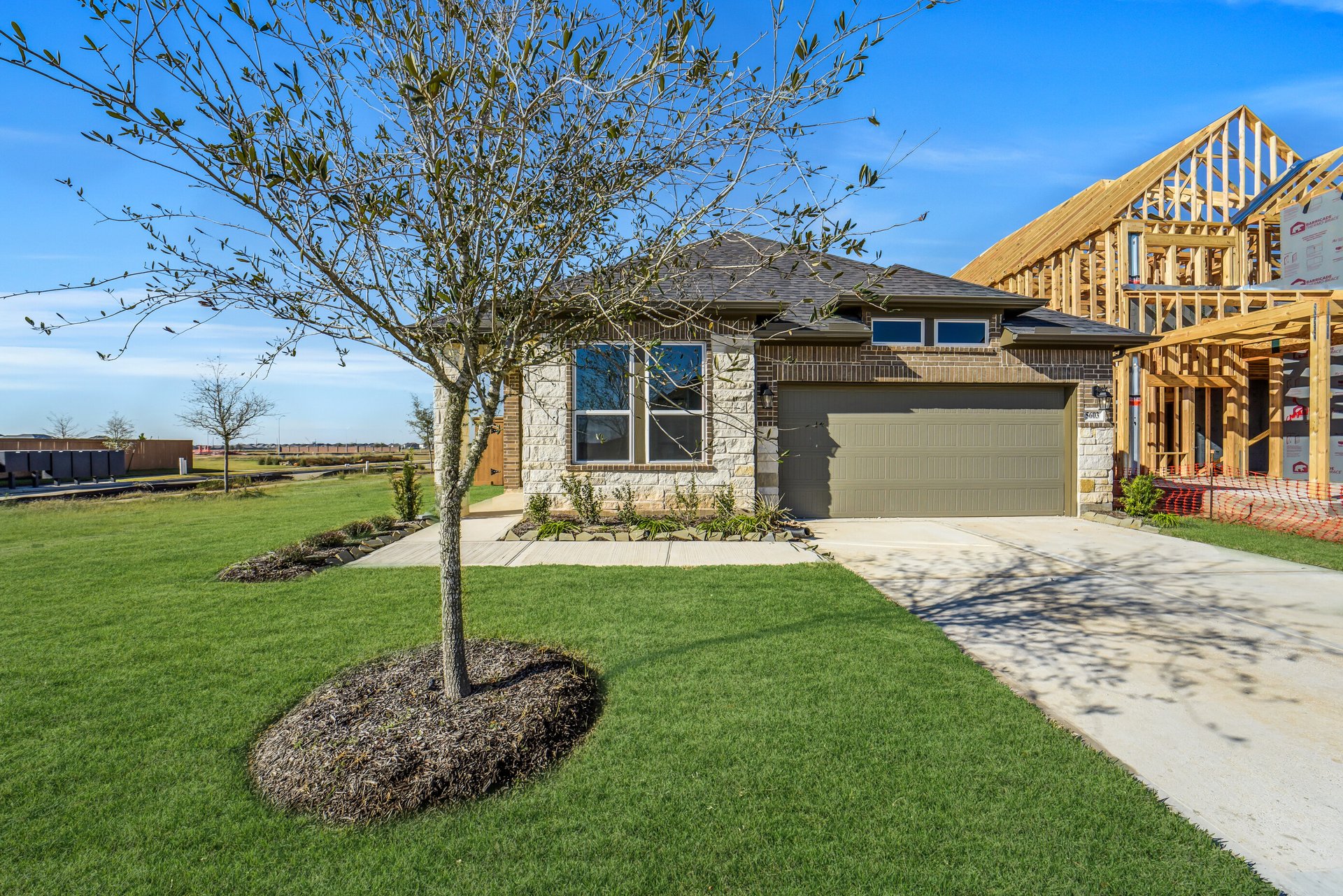 exterior of home with brown brick and white stone