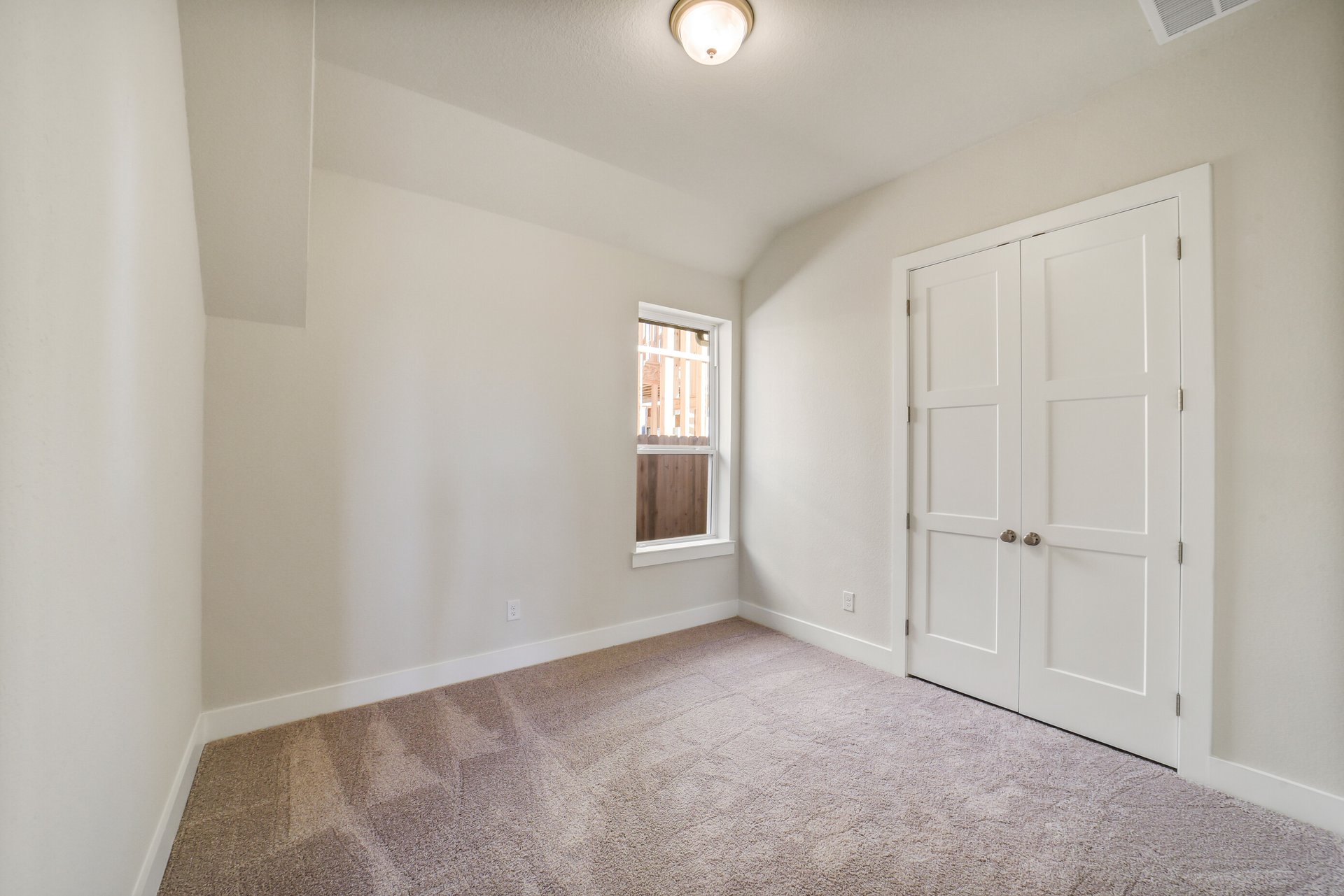 guest bedroom with carpet and window